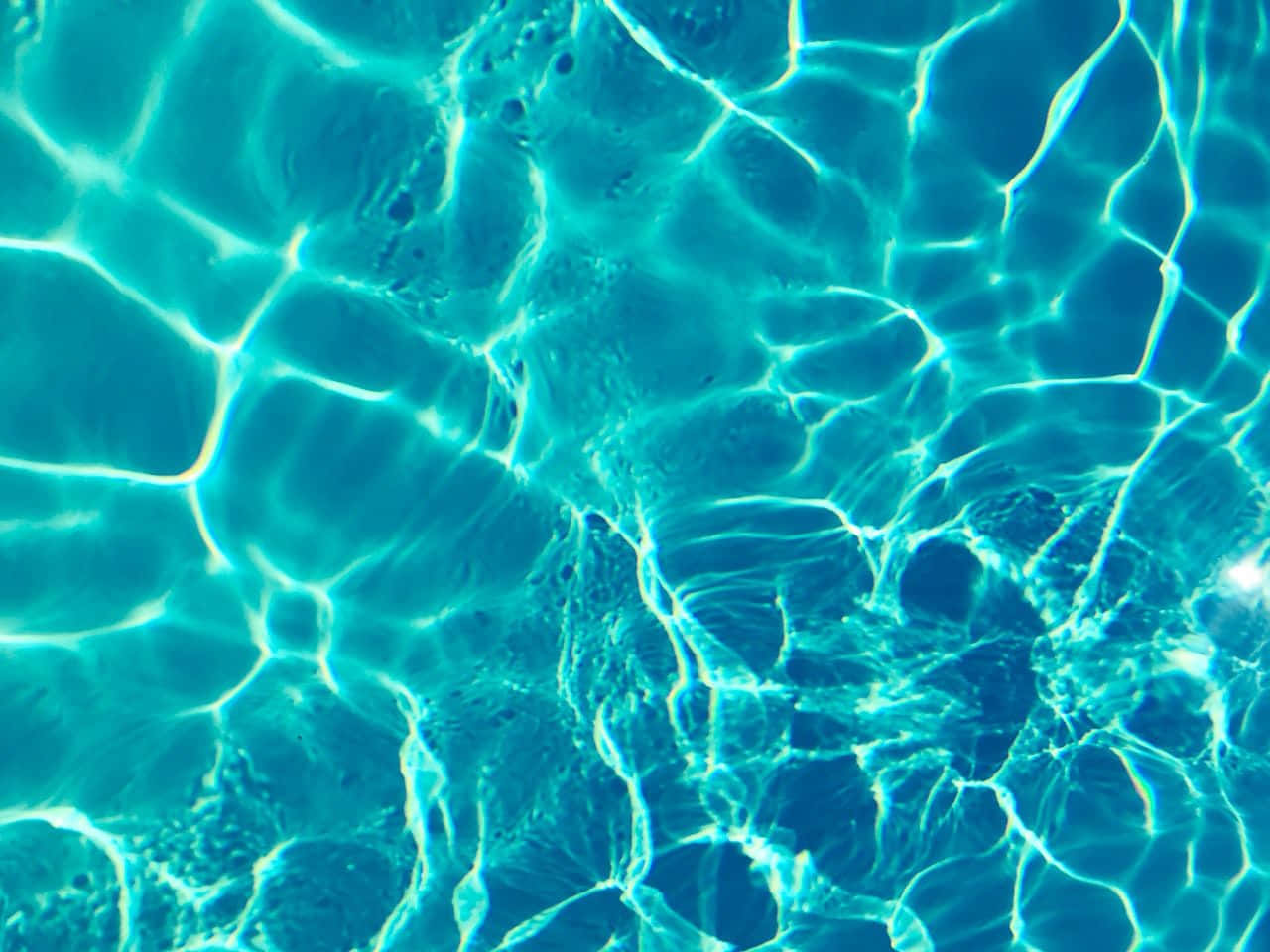 A Close Up Of A Blue Pool With Clear Water Background