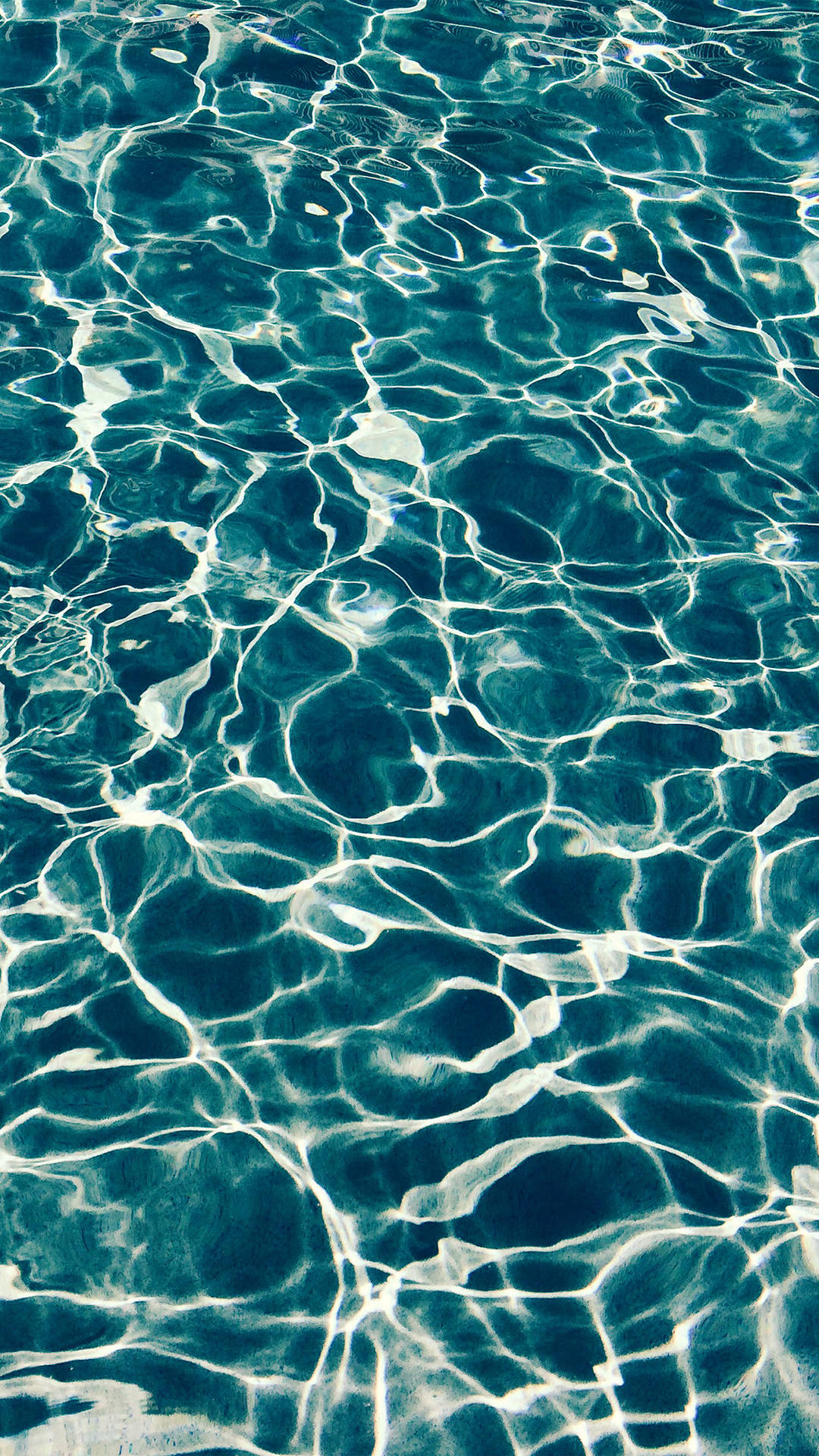 A Close Up Of A Blue Pool With Ripples Background