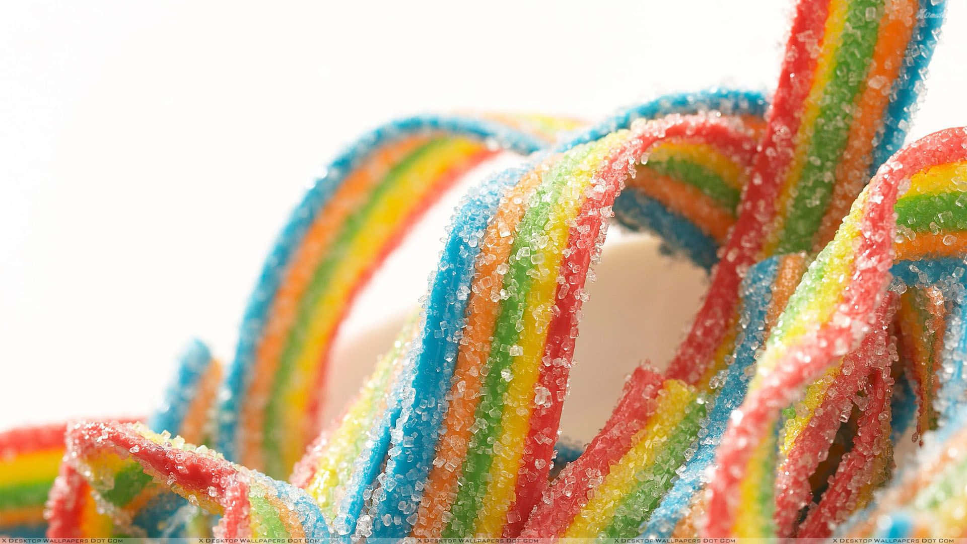 A Close Up Of A Rainbow Colored Candy Background