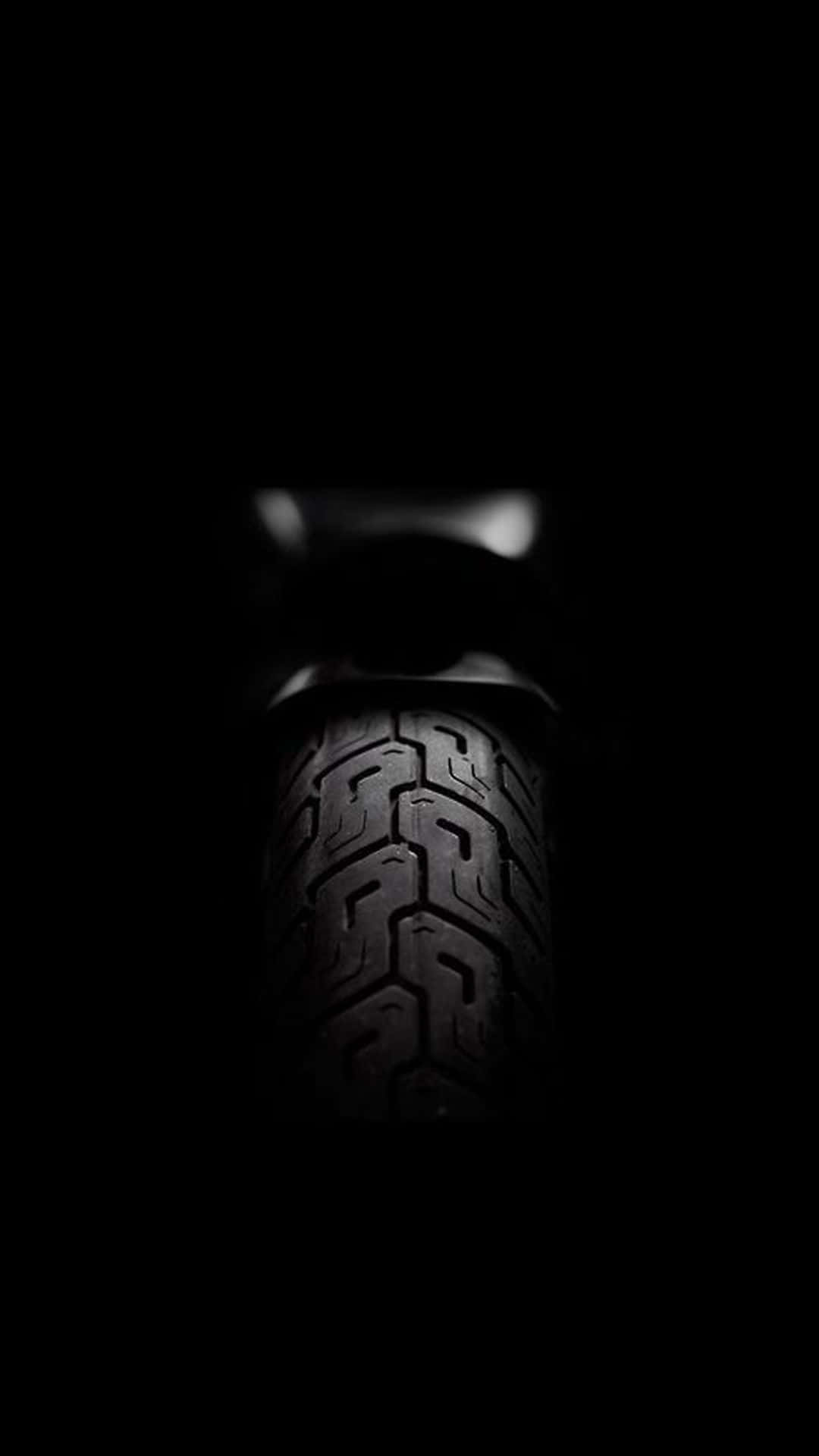 A Close Up Of A Tire In The Dark