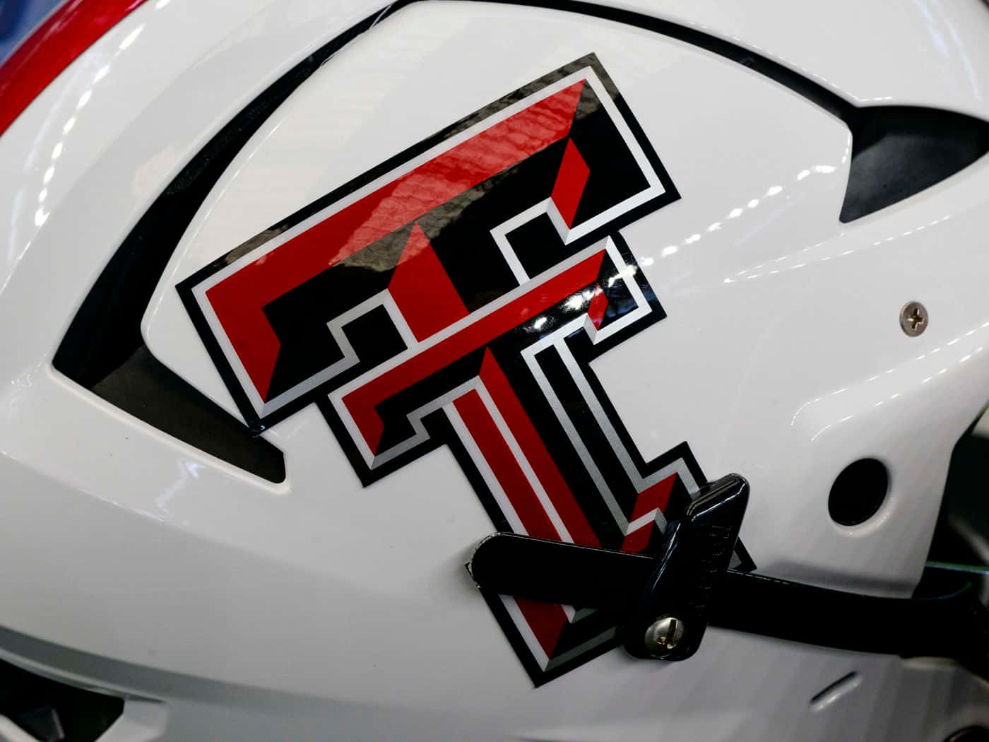 A Close Up Of A White Helmet With A Red And Black Logo Background