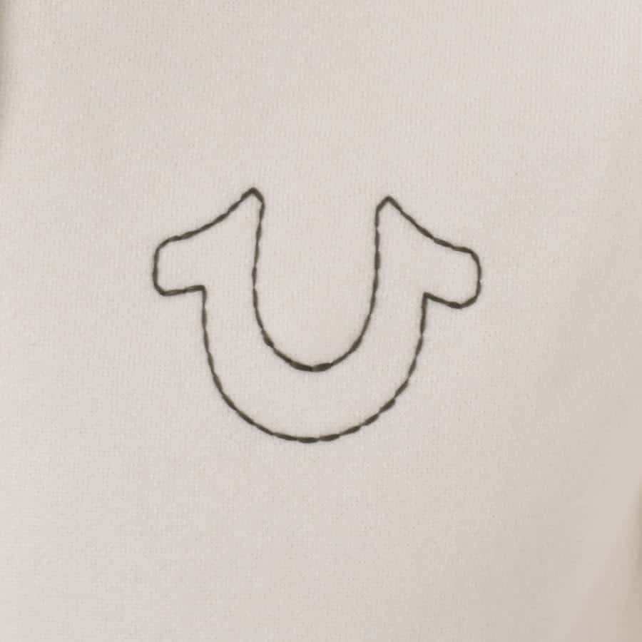 A Close Up Of A White Shirt With A U Embroidered On It Background