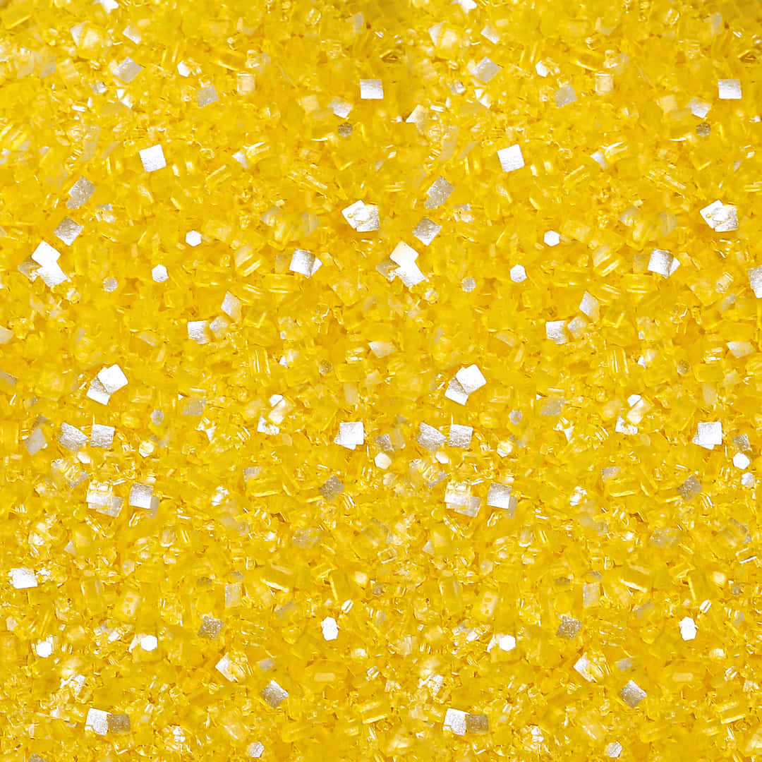 A Close Up Of A Yellow And Silver Glitter Background