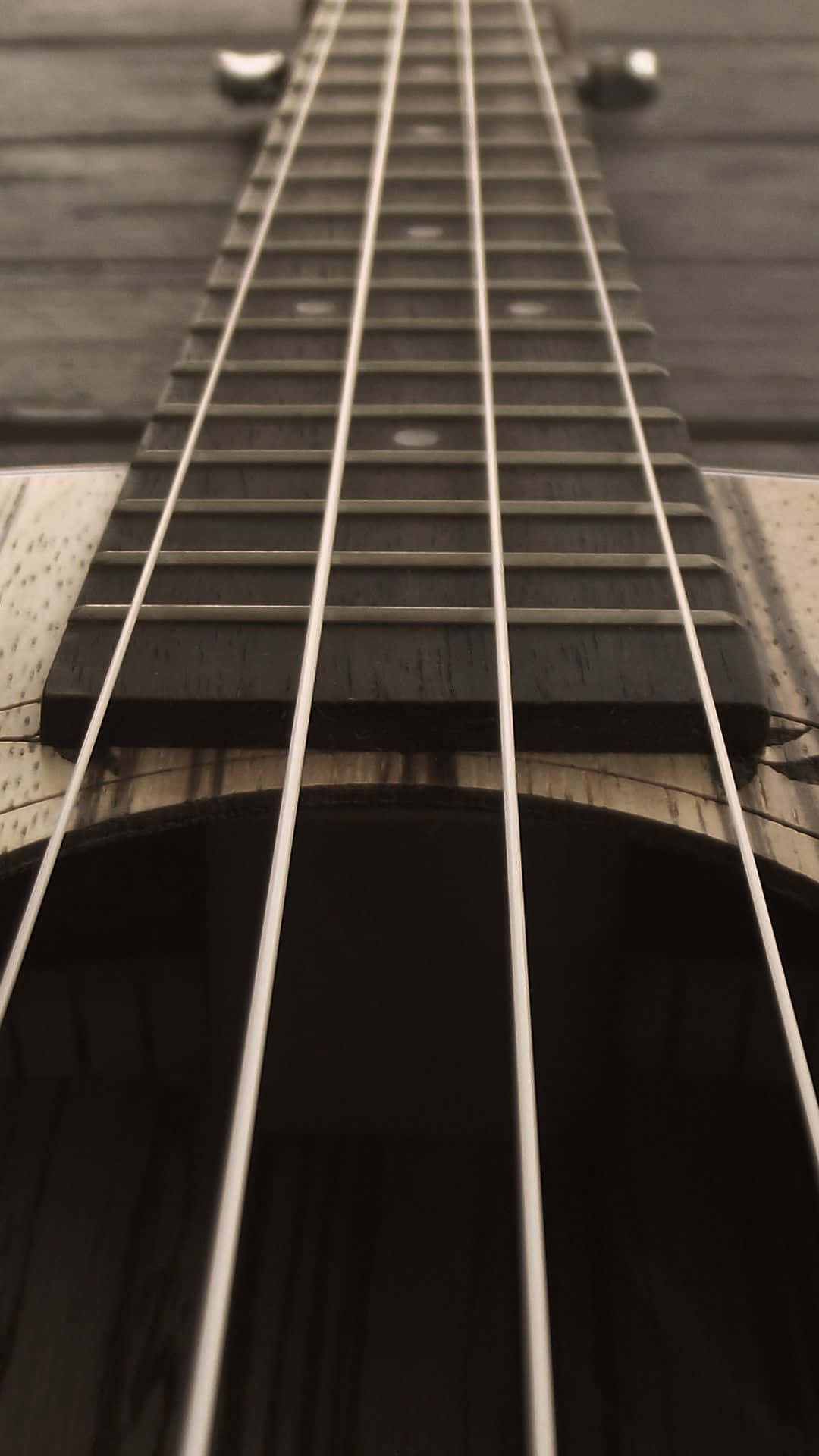 A Close Up Of The Strings Of An Acoustic Guitar