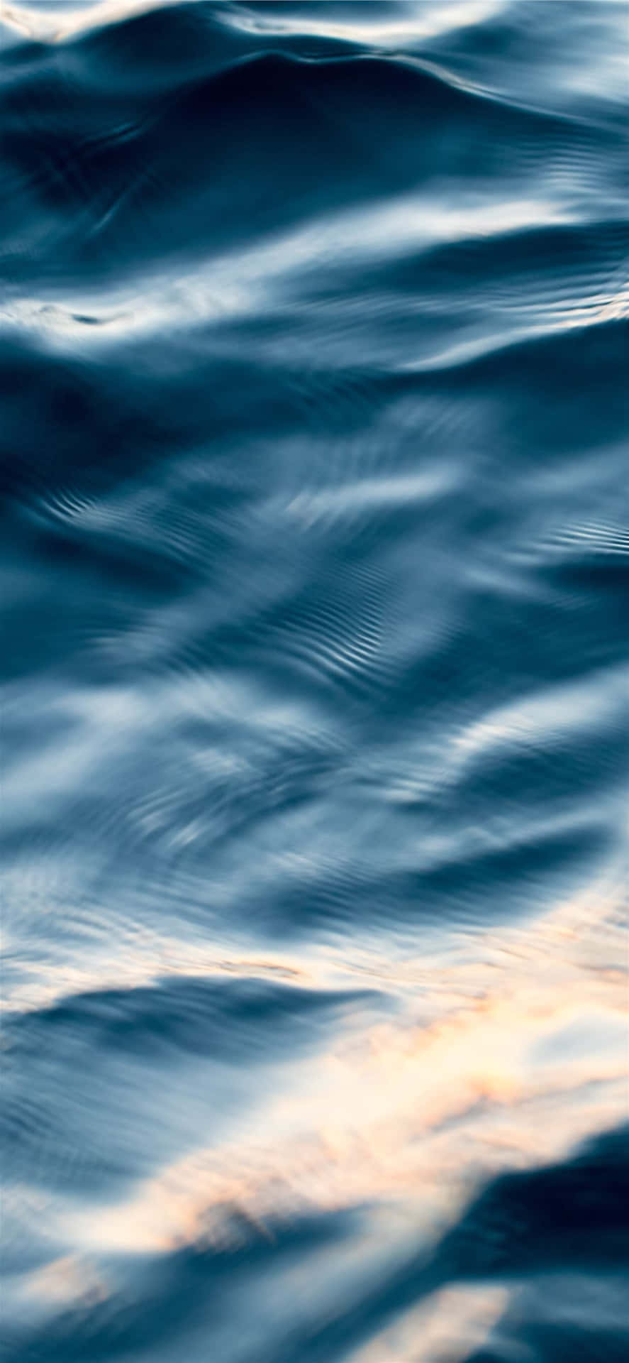 A Close Up Of The Water Surface At Sunset Background