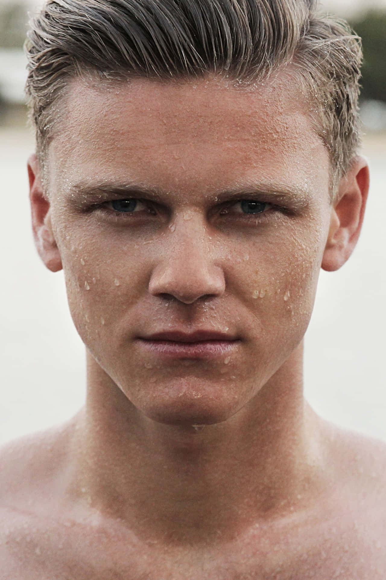 A Close-up Shot Of A Man Covered In Sweat