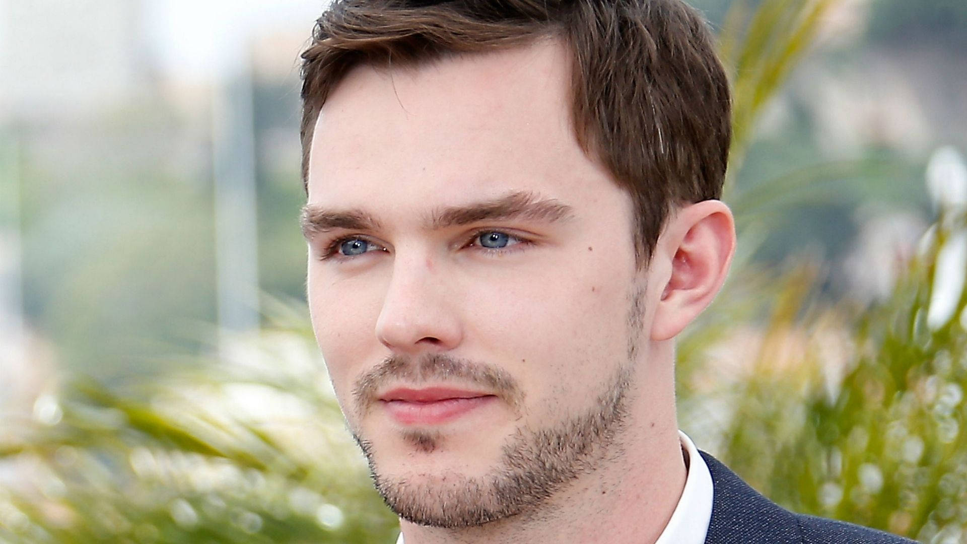 A Close-up Shot Of Actor Nicholas Hoult With A Bright Expression. Background