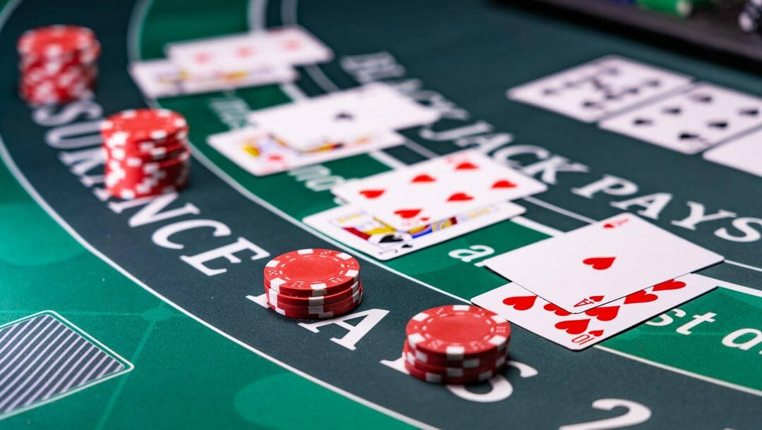 A Close-up View Of A Blackjack Game With Cards And Chips. Background