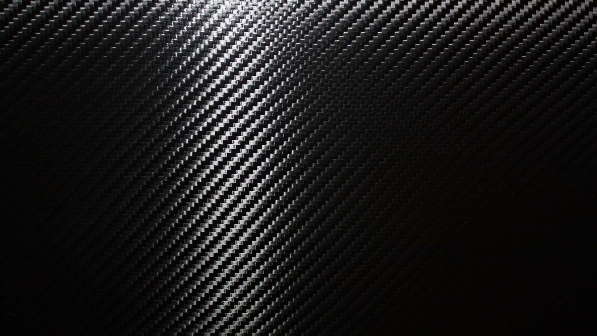 A Close-up View Of Black Carbon Fiber In A Luxurious Pattern Background