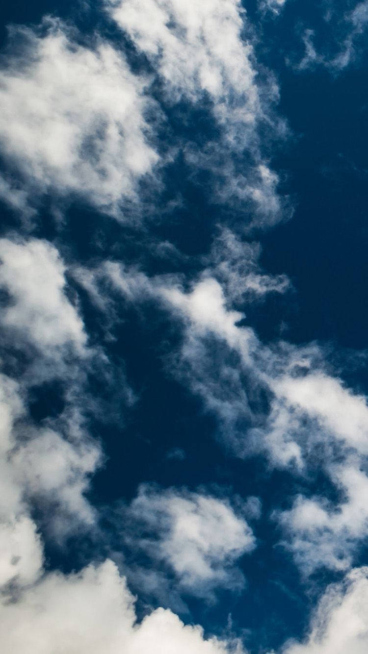 A Cloudy Sky From The Heights Of Iphone Background