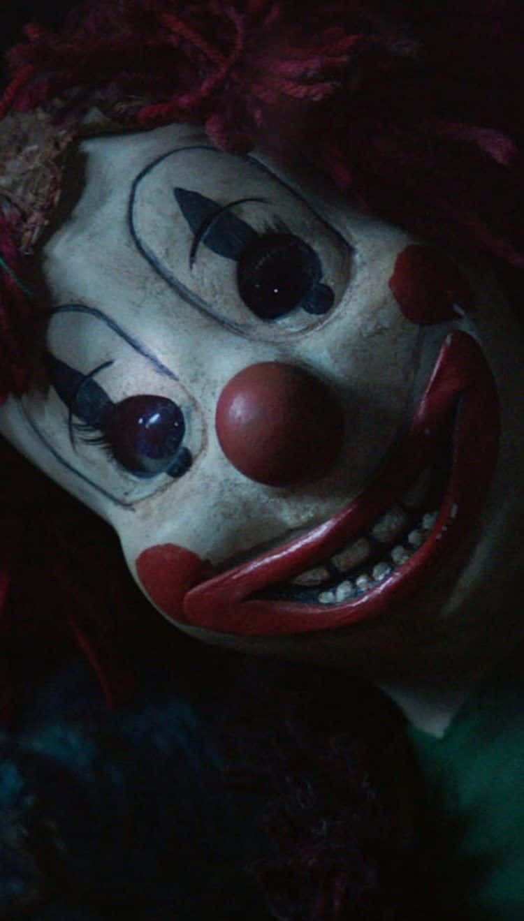 A Clown With Red Hair And A Red Nose