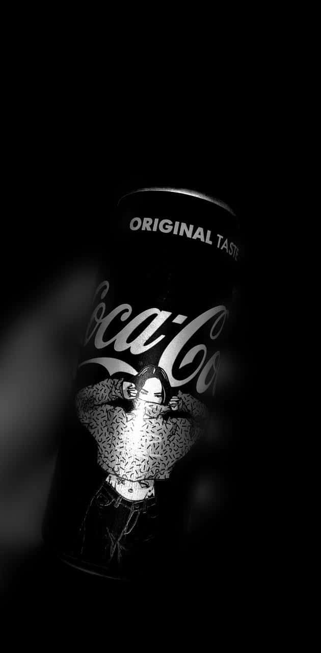 A Coca Cola Can Is Shown In The Dark Background