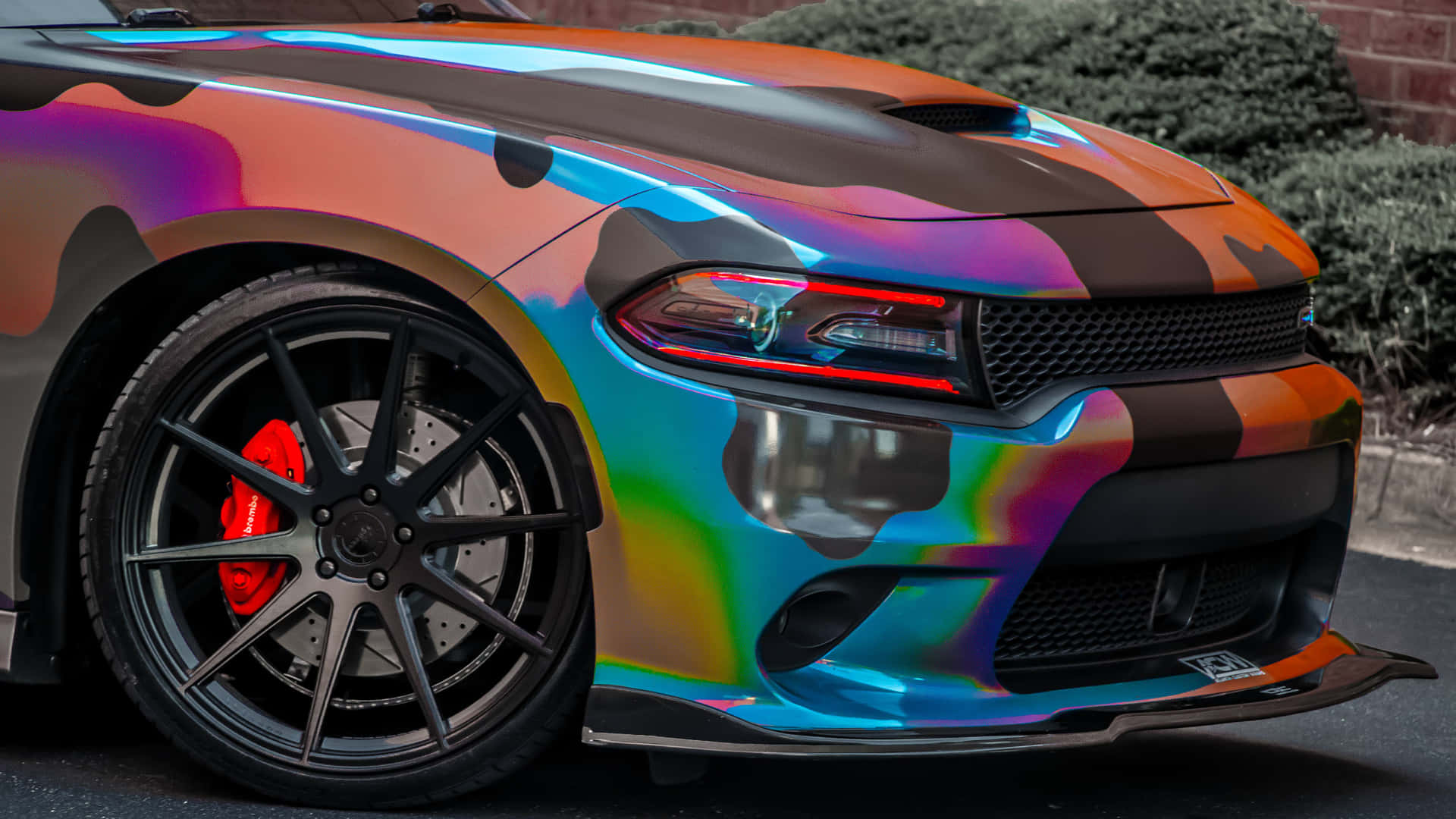 A Colorful Car With A Rainbow Colored Paint Job Background