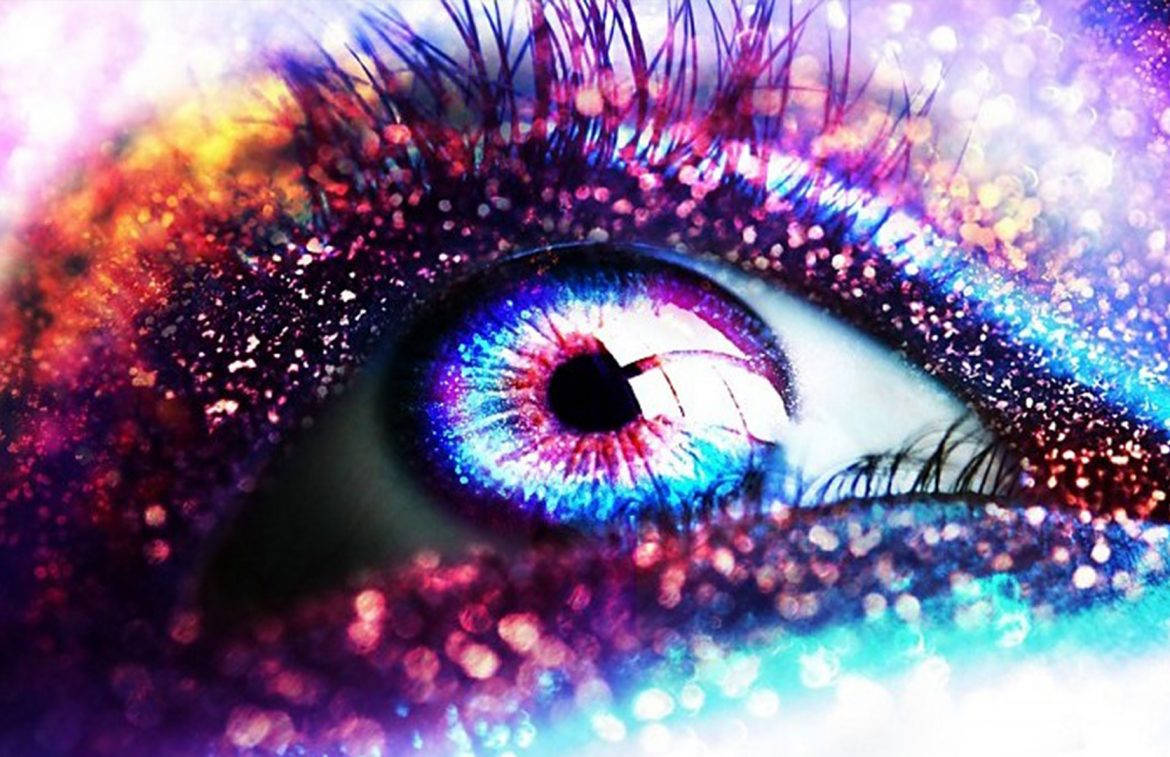 A Colorful Eye With Glitter And Sparkles Background