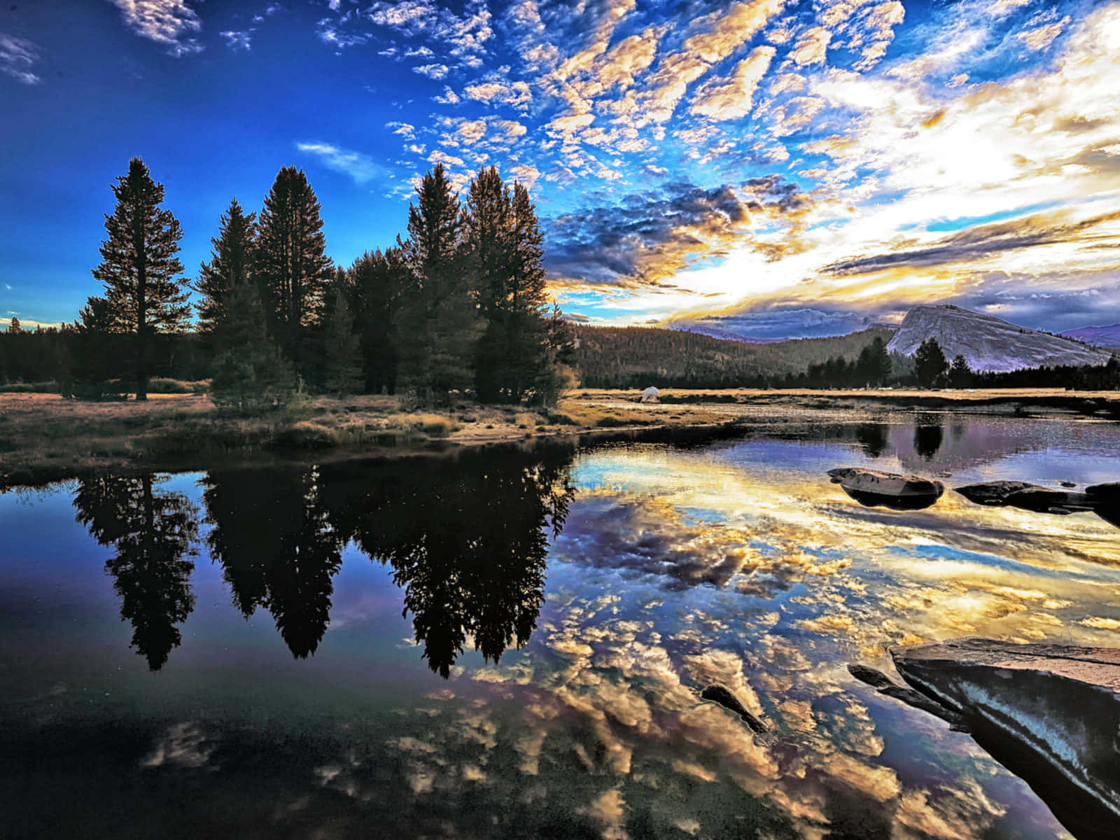 A Colorful Landscape Of A Lake Surrounded By Mountains