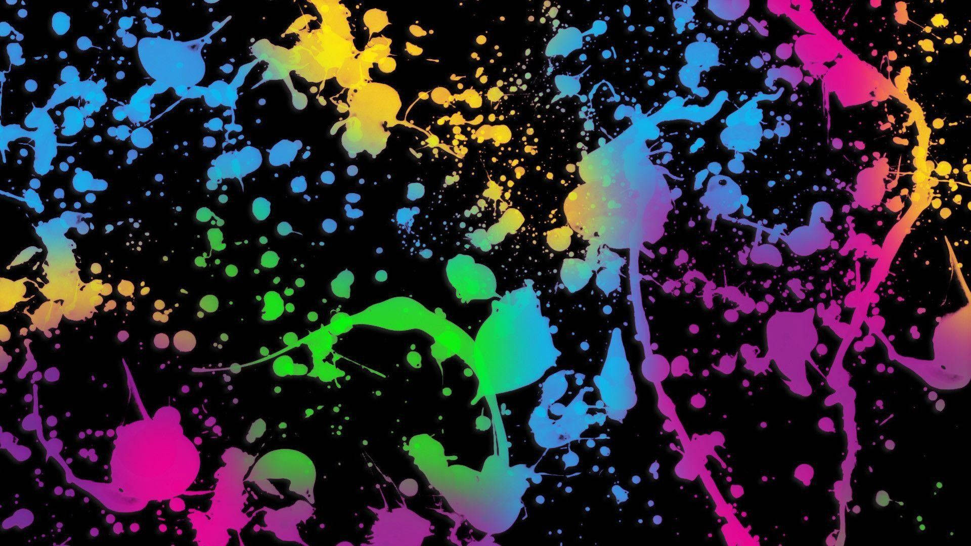 A Colorful Paint Splatter On A Black Background Background