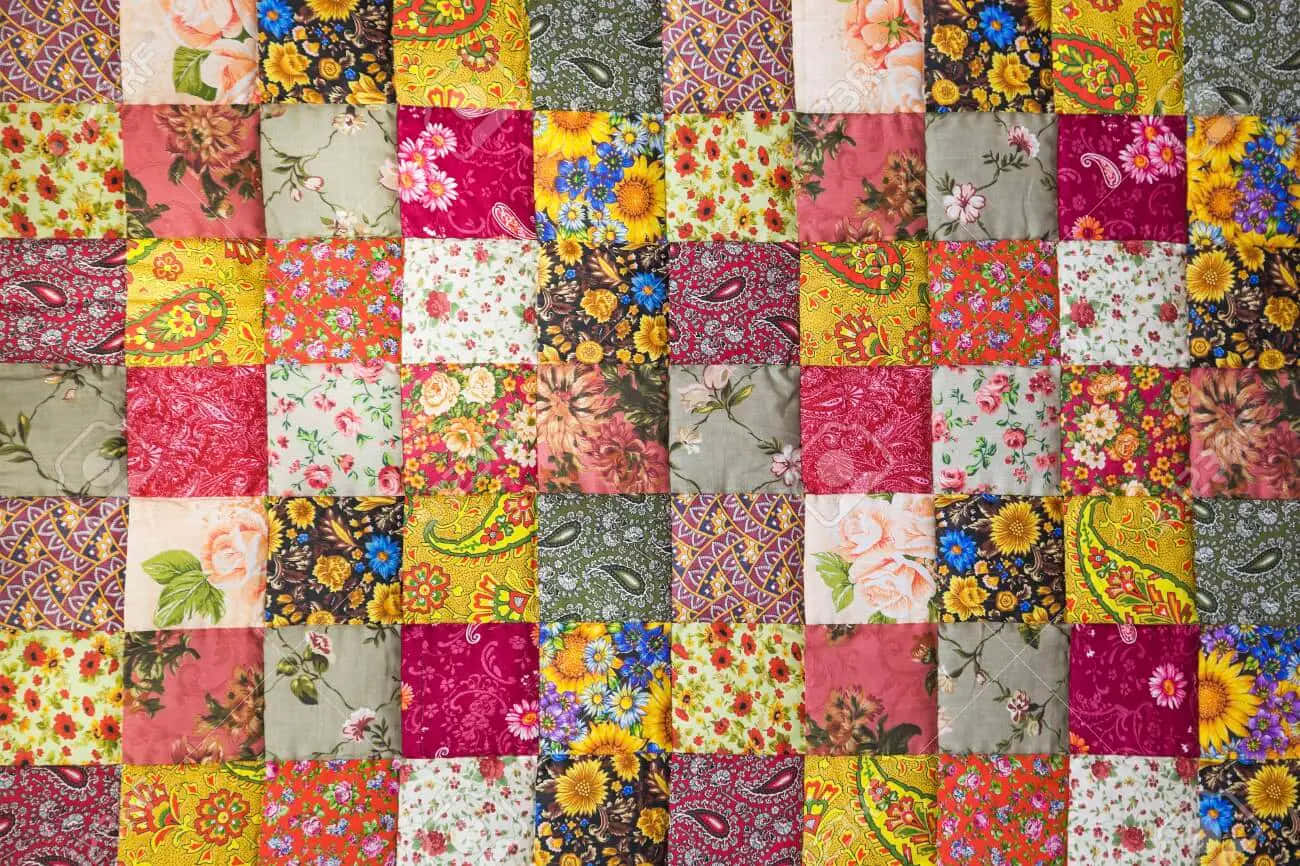A Colorful Quilt With A Floral Pattern Background