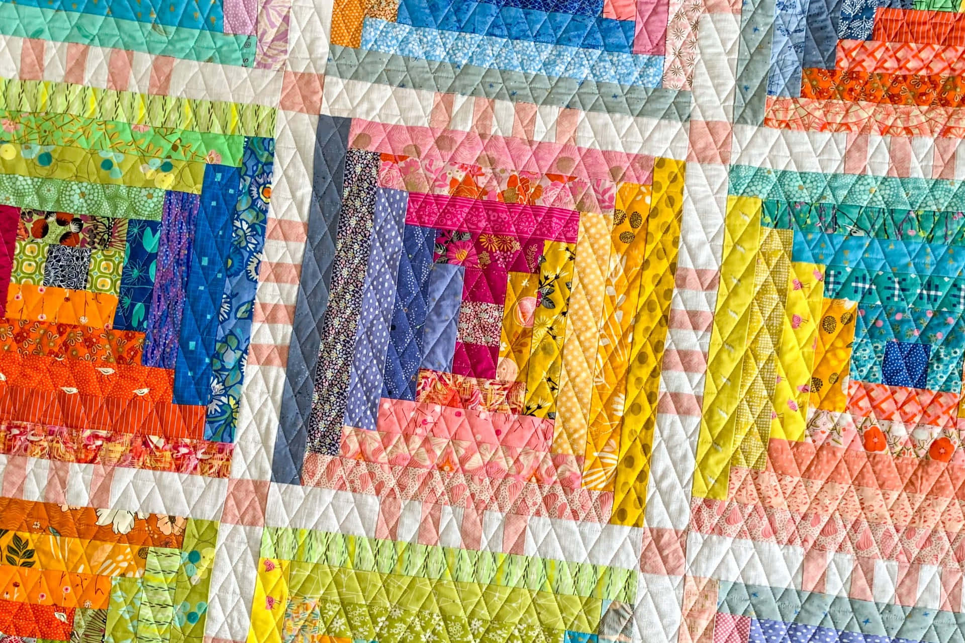 A Colorful Quilt With Blocks Made Of Different Colors Background