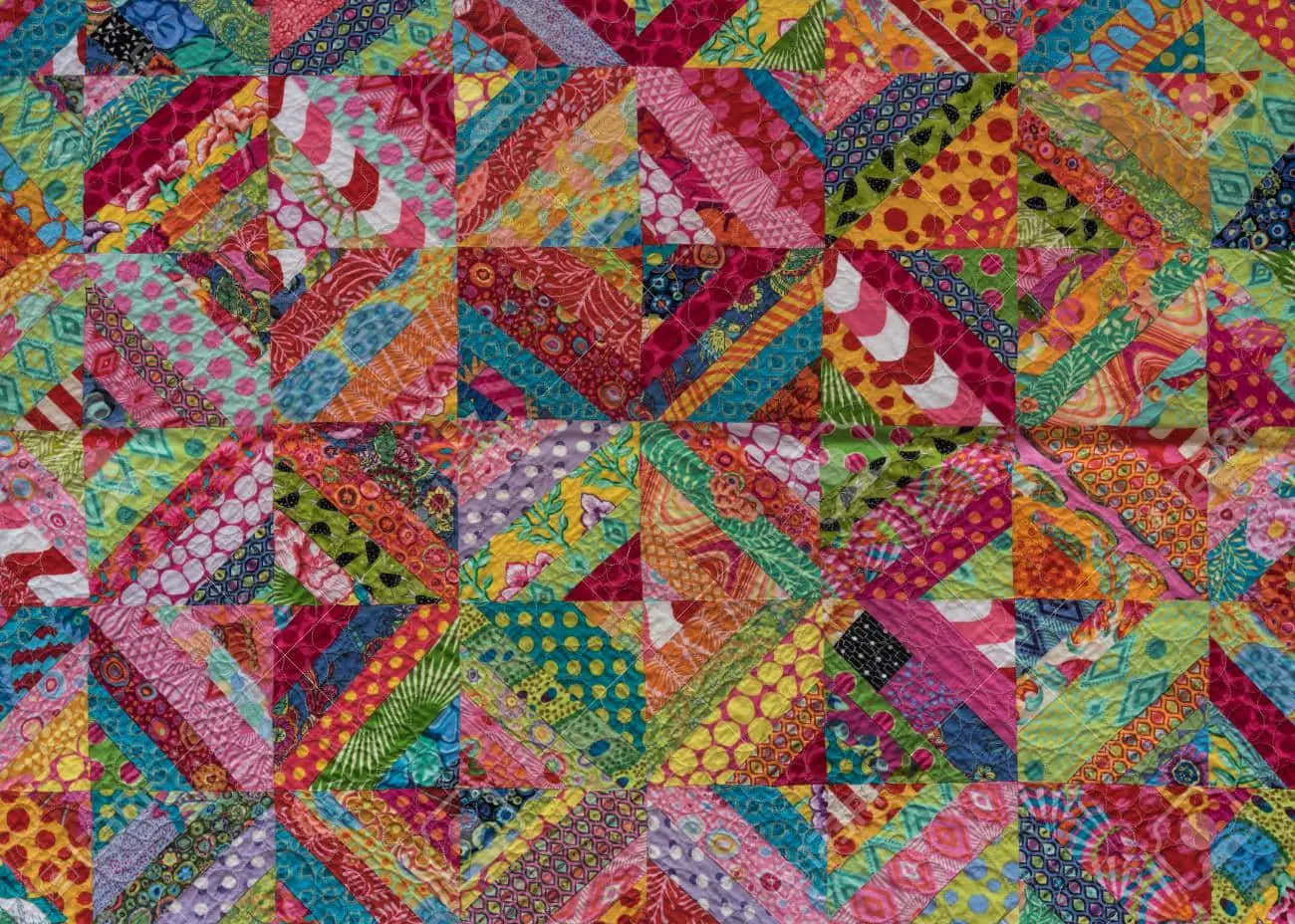 A Colorful Quilt With Many Colorful Squares Background
