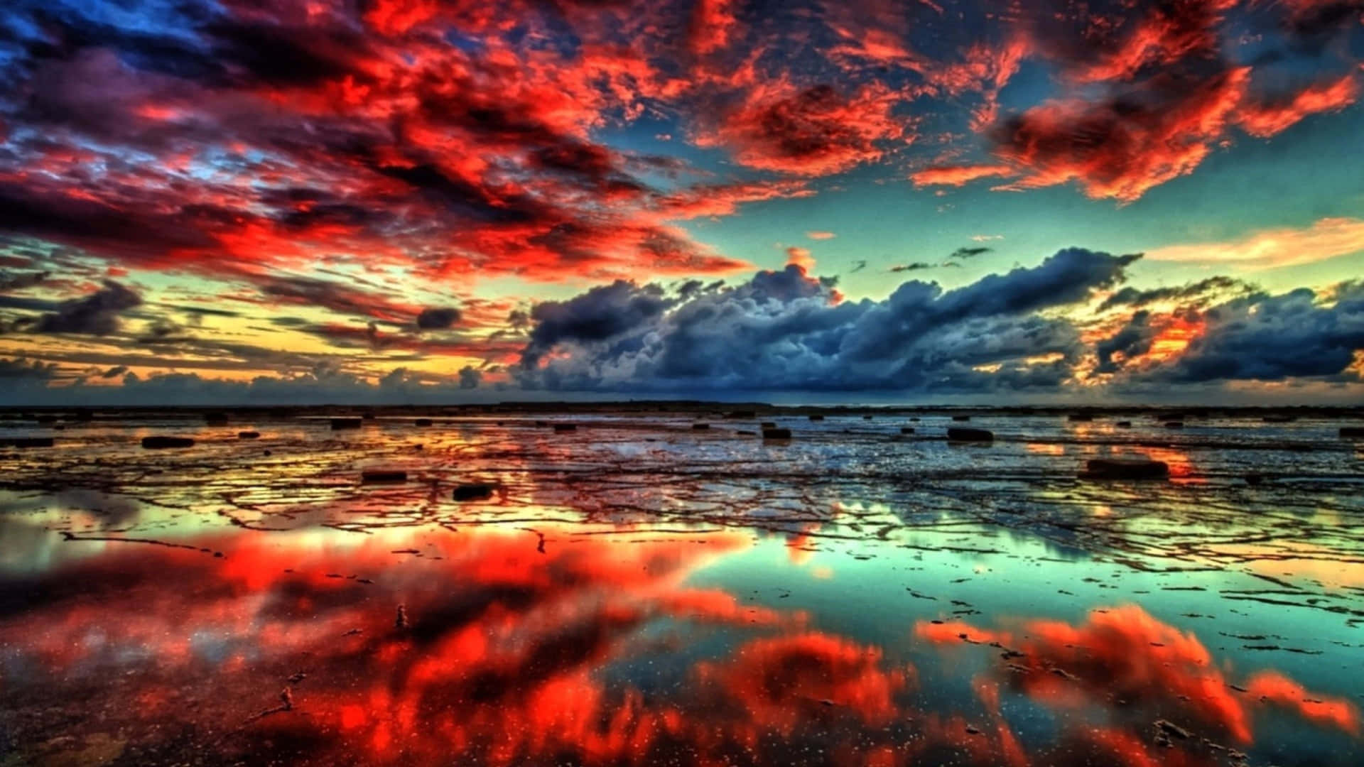 A Colorful Sunset With Clouds Reflected In The Water Background