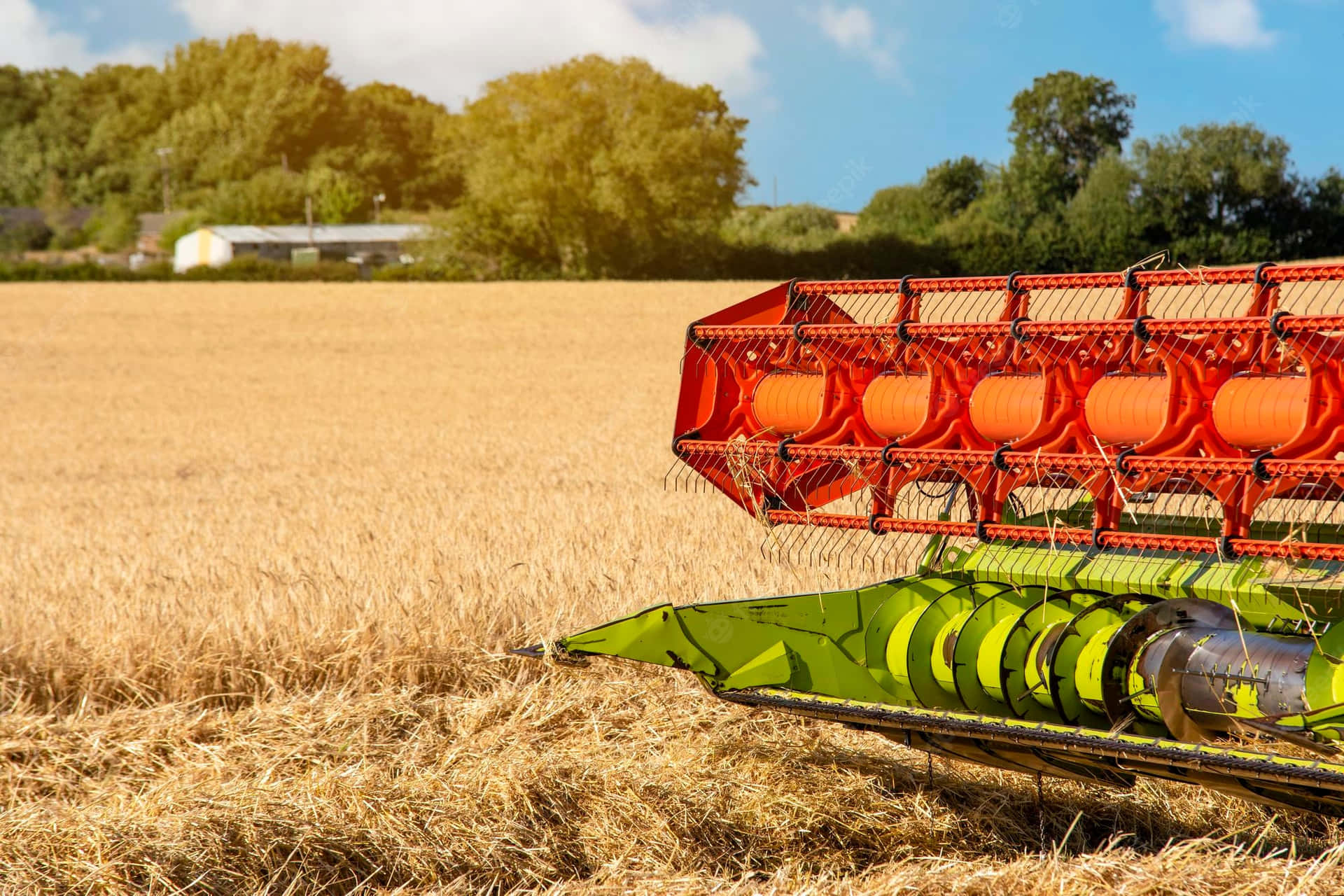 A Combine Harvester Is In The Field Background