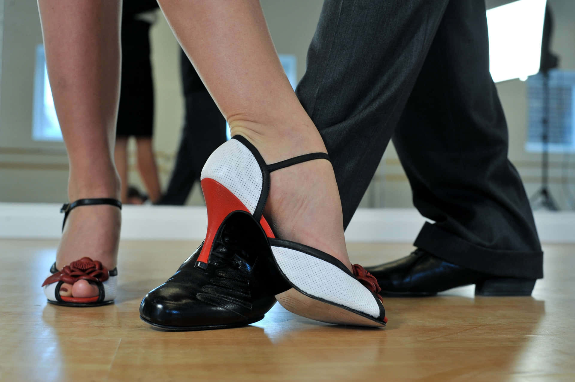 A Couple Of People In Black And White Shoes Standing In A Dance Studio