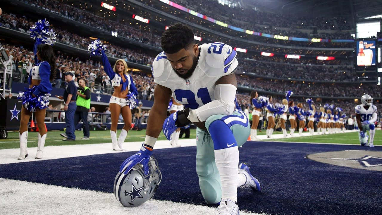 A Cowboy Player Kneeling On The Field Background