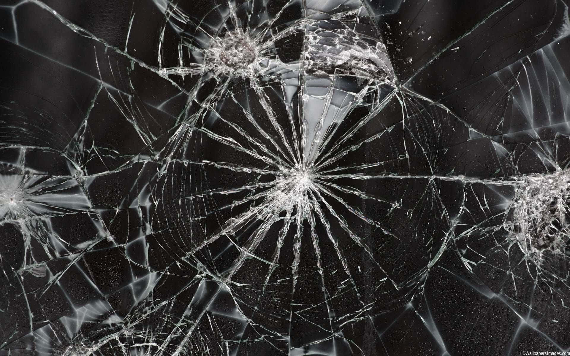 A Cracked Computer Screen Showcasing A Shattered Image Background