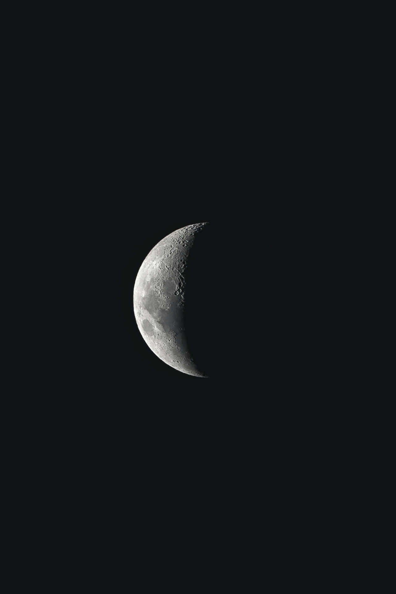 A Crescent Is Seen In The Dark Sky Background