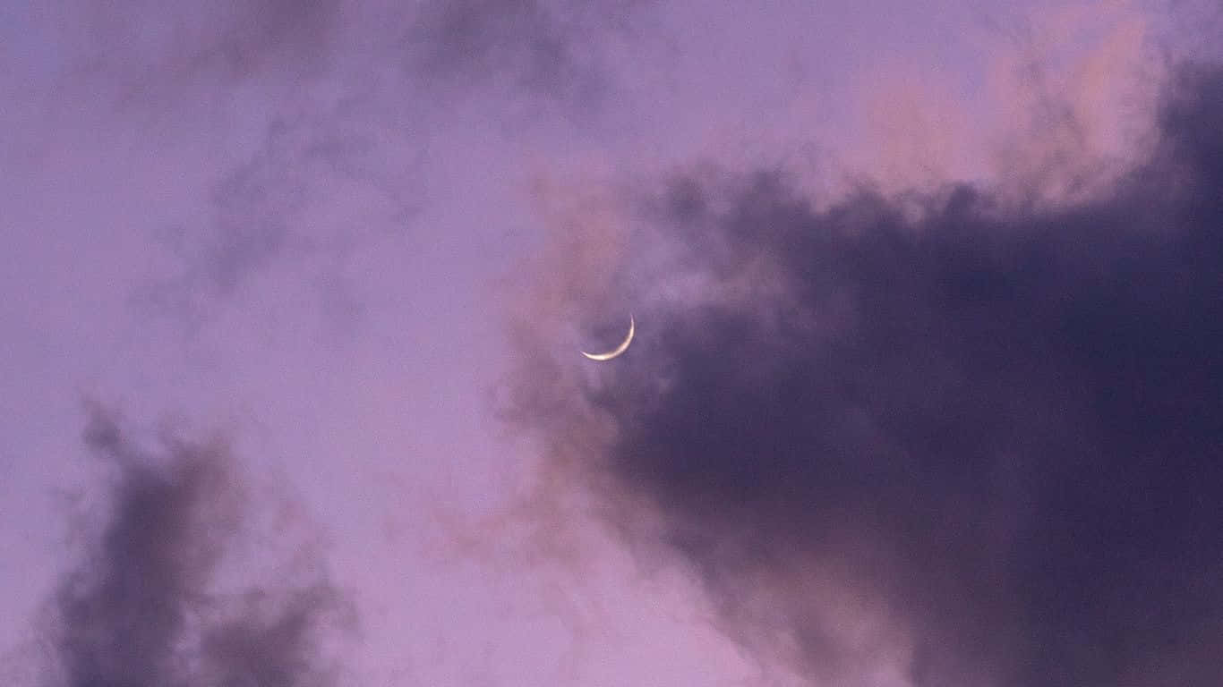 A Crescent Is Seen In The Sky Background