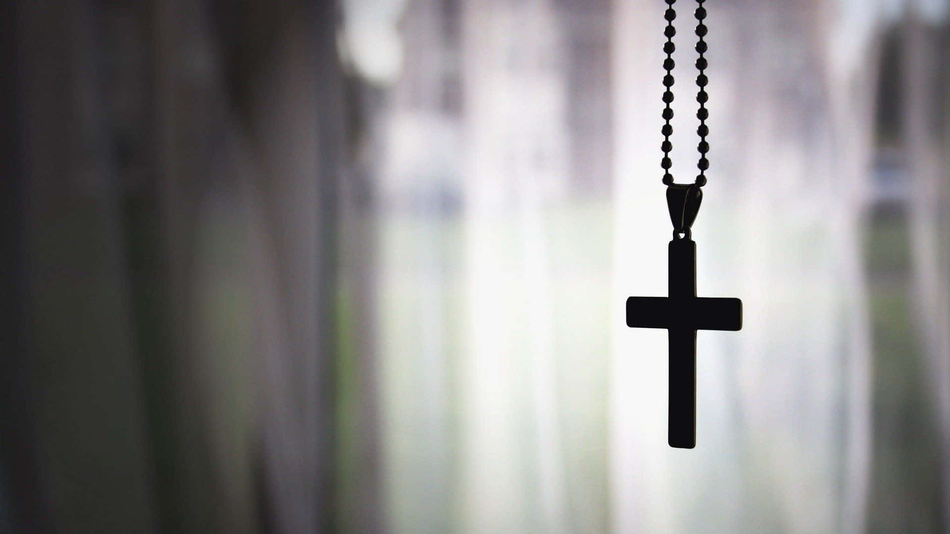 A Cross Hanging From A Curtain