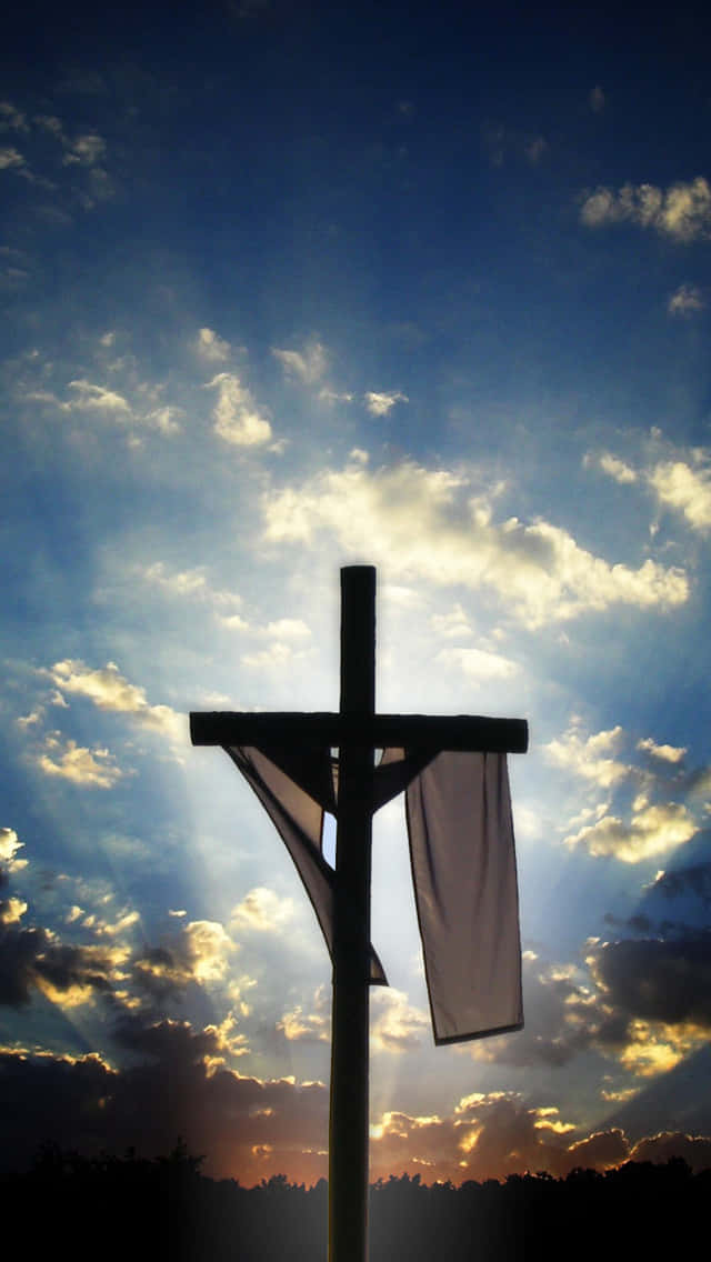 A Cross With A White Cloth Hanging From It