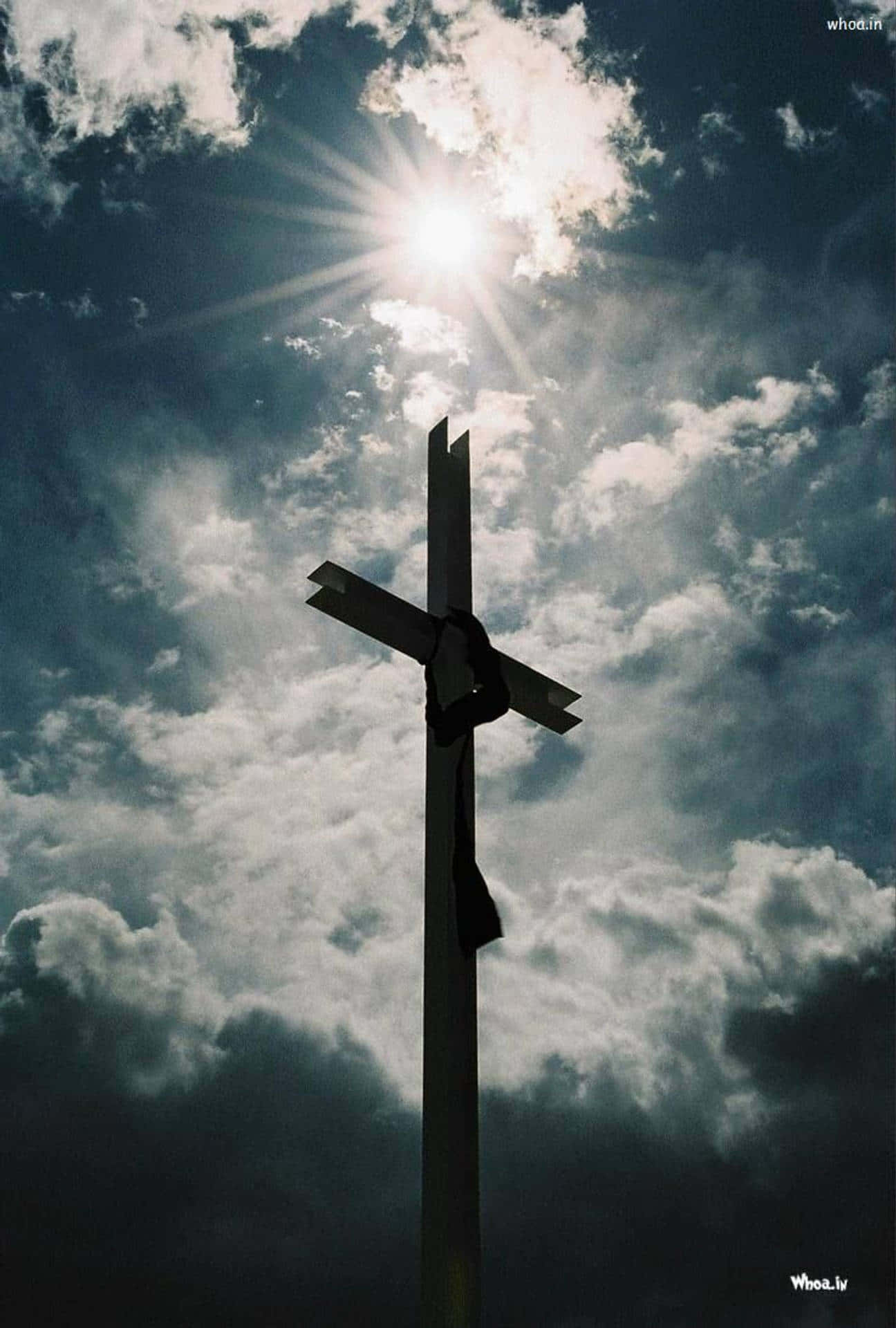 A Cross With Clouds In The Sky Background