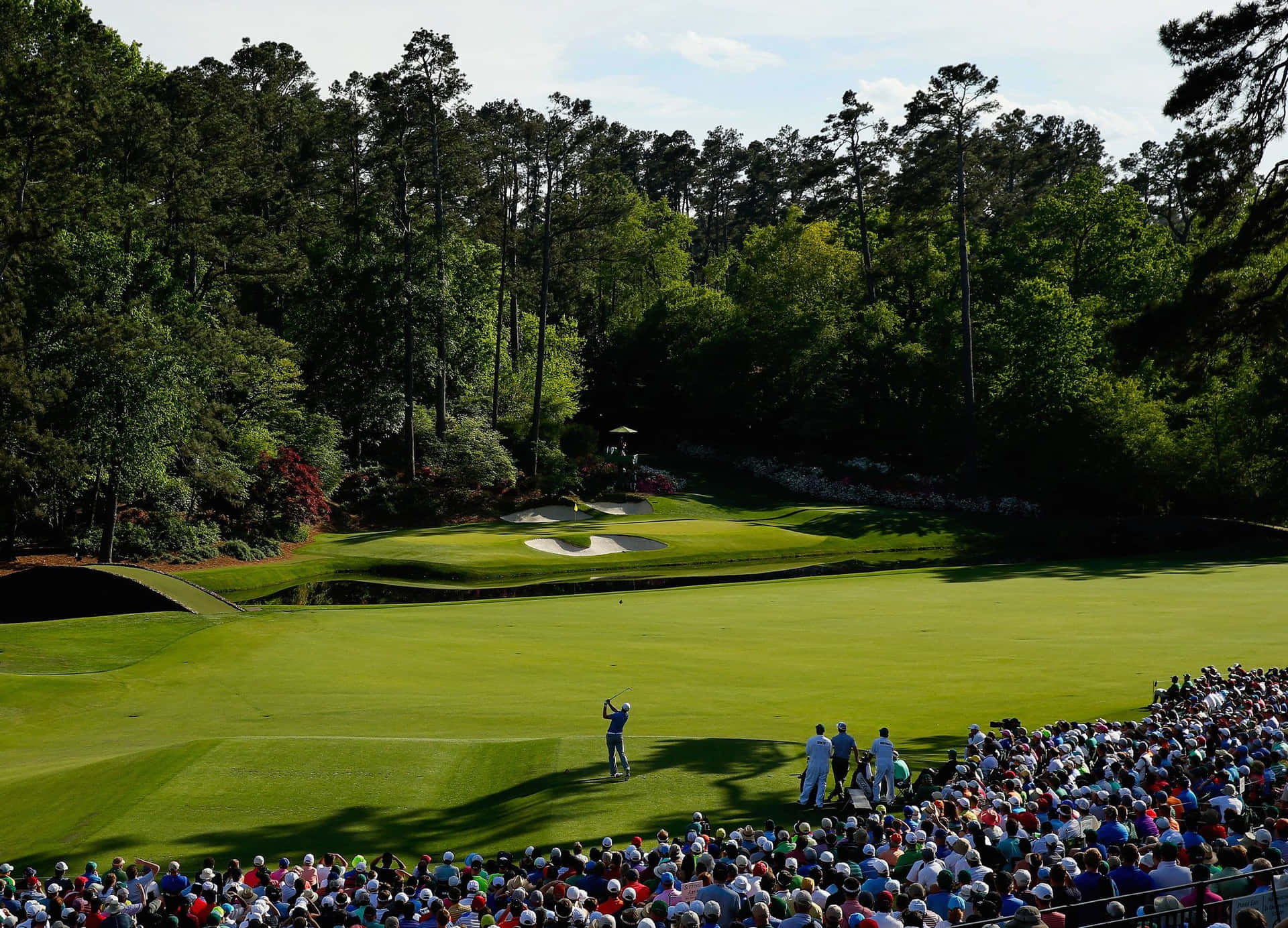 A Crowd Watches A Golf Tournament On A Green