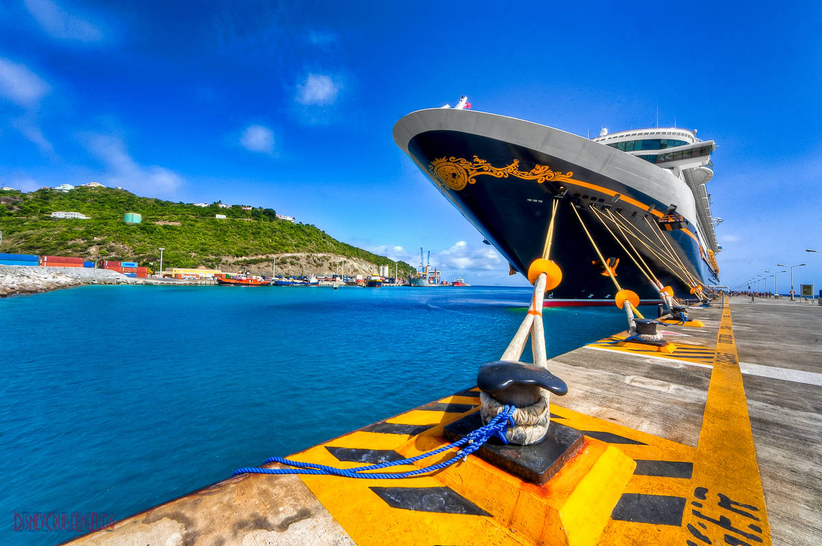 A Cruise Ship Docked In Sint Maarten Beach Background