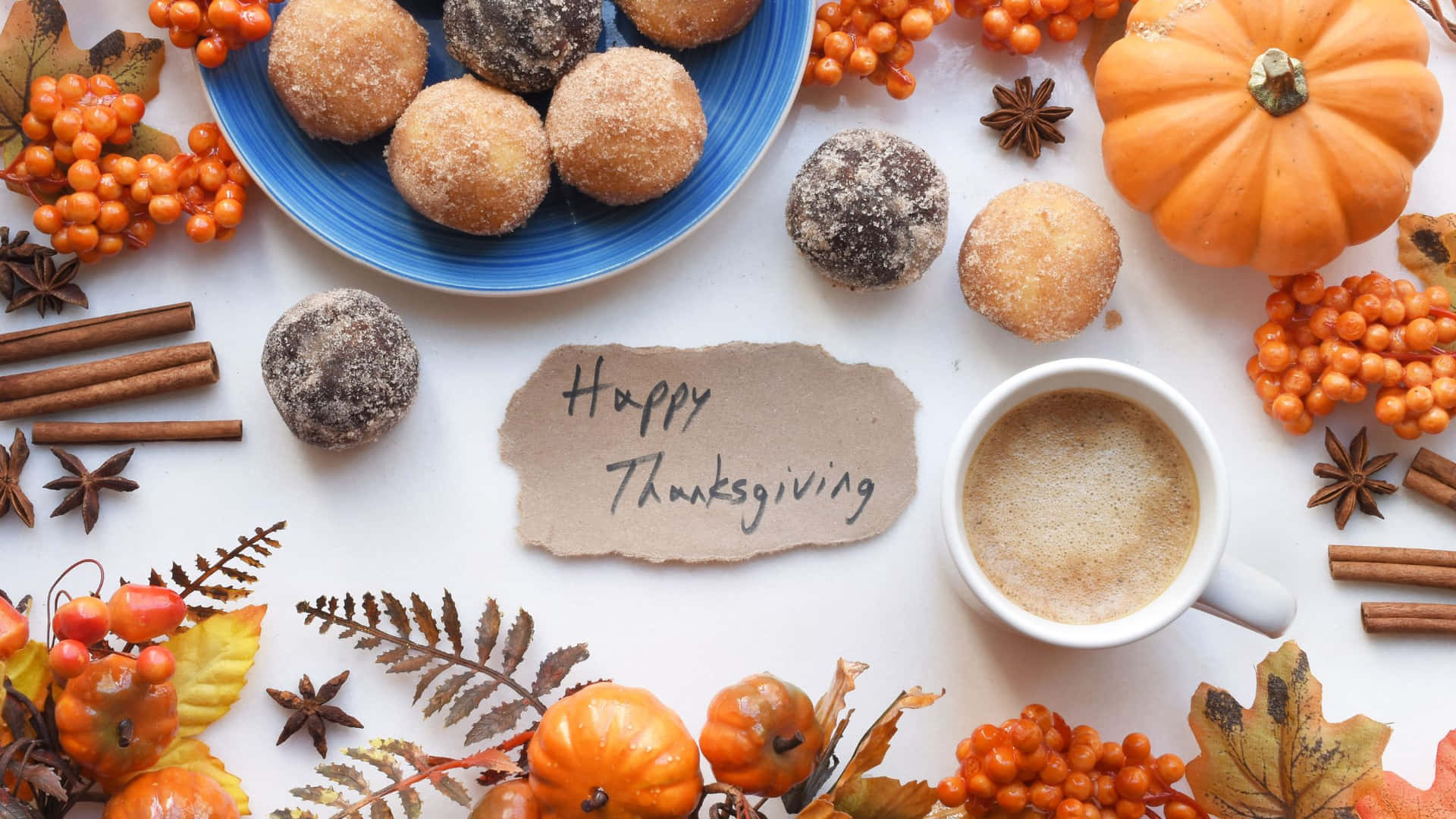 A Cup Of Coffee And Donuts With The Words Happy Thanksgiving Background