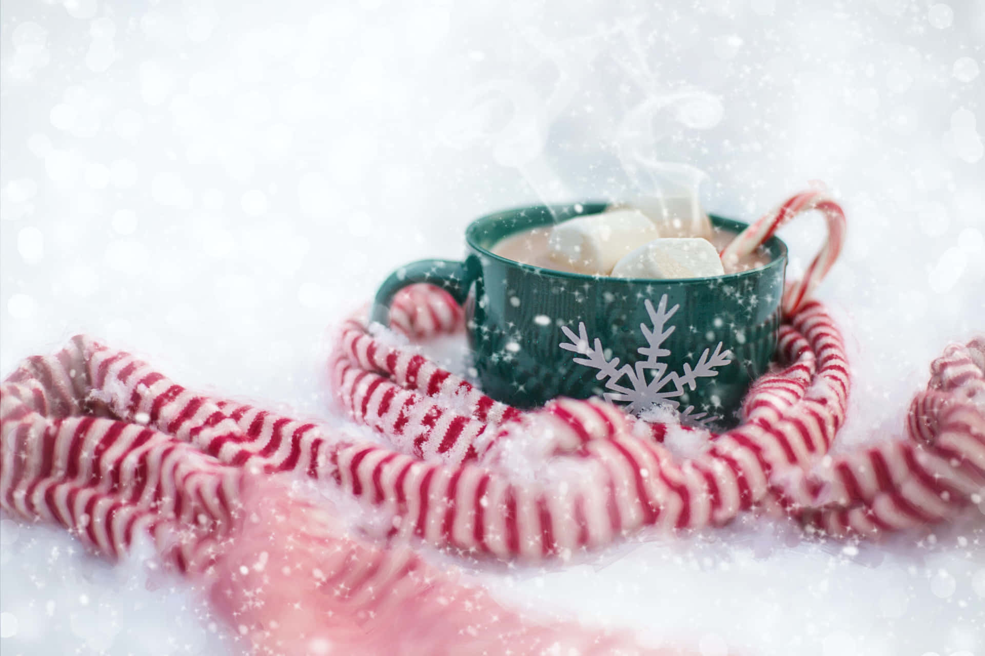 A Cup Of Hot Cocoa With Candy Canes On A Snowy Background Background