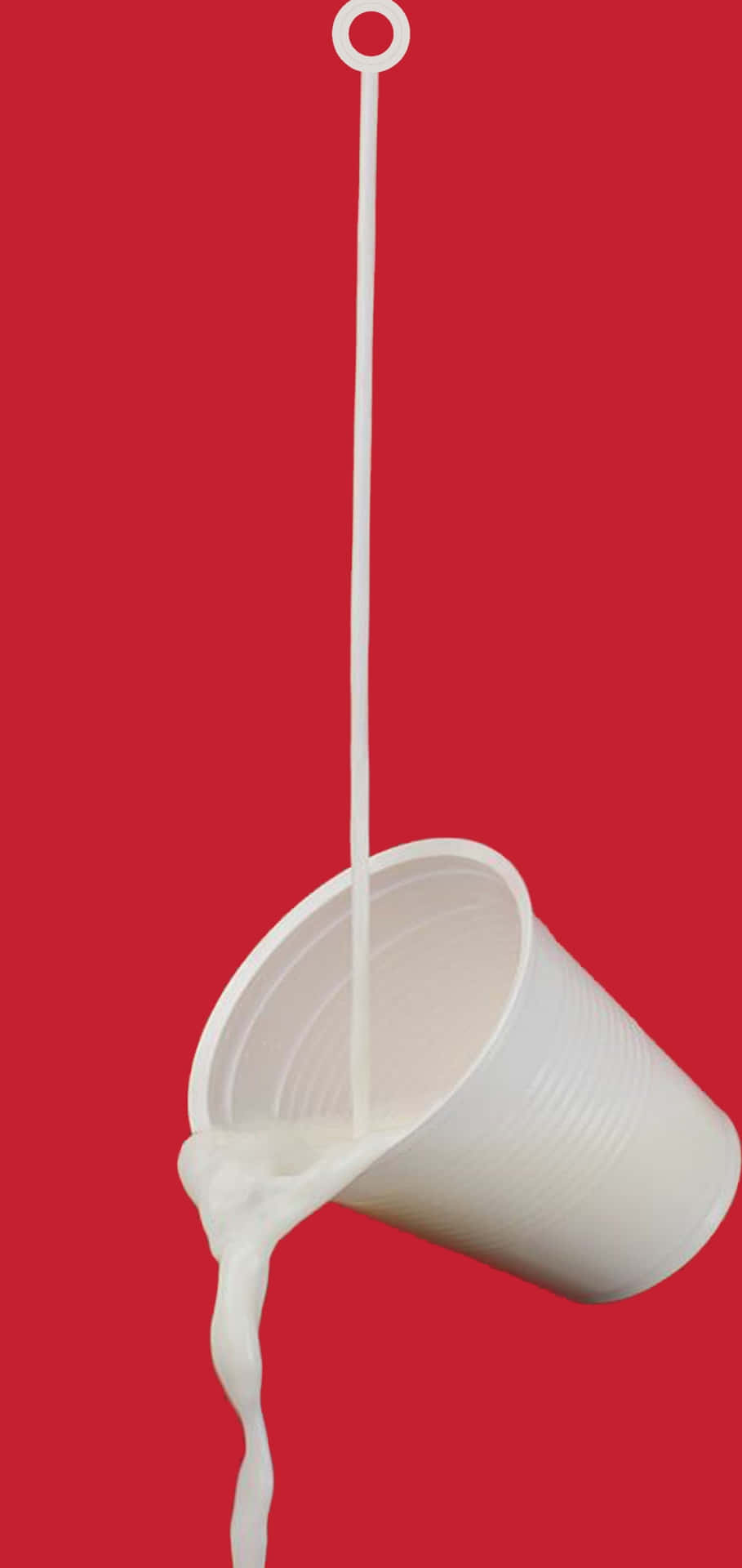 A Cup Of Milk Is Dripping From A Red Background