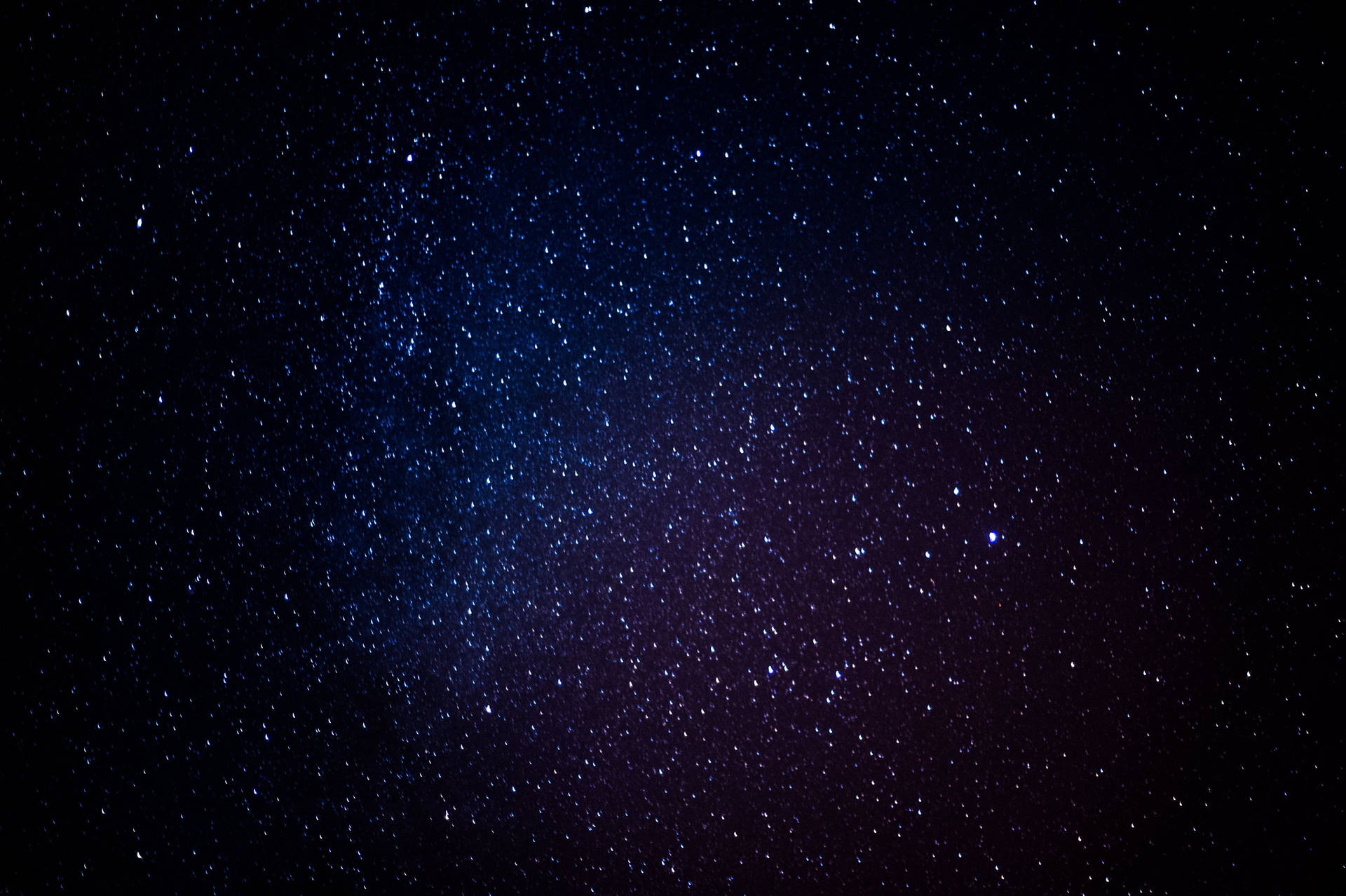 A Dark Blue Sky With Stars In The Background