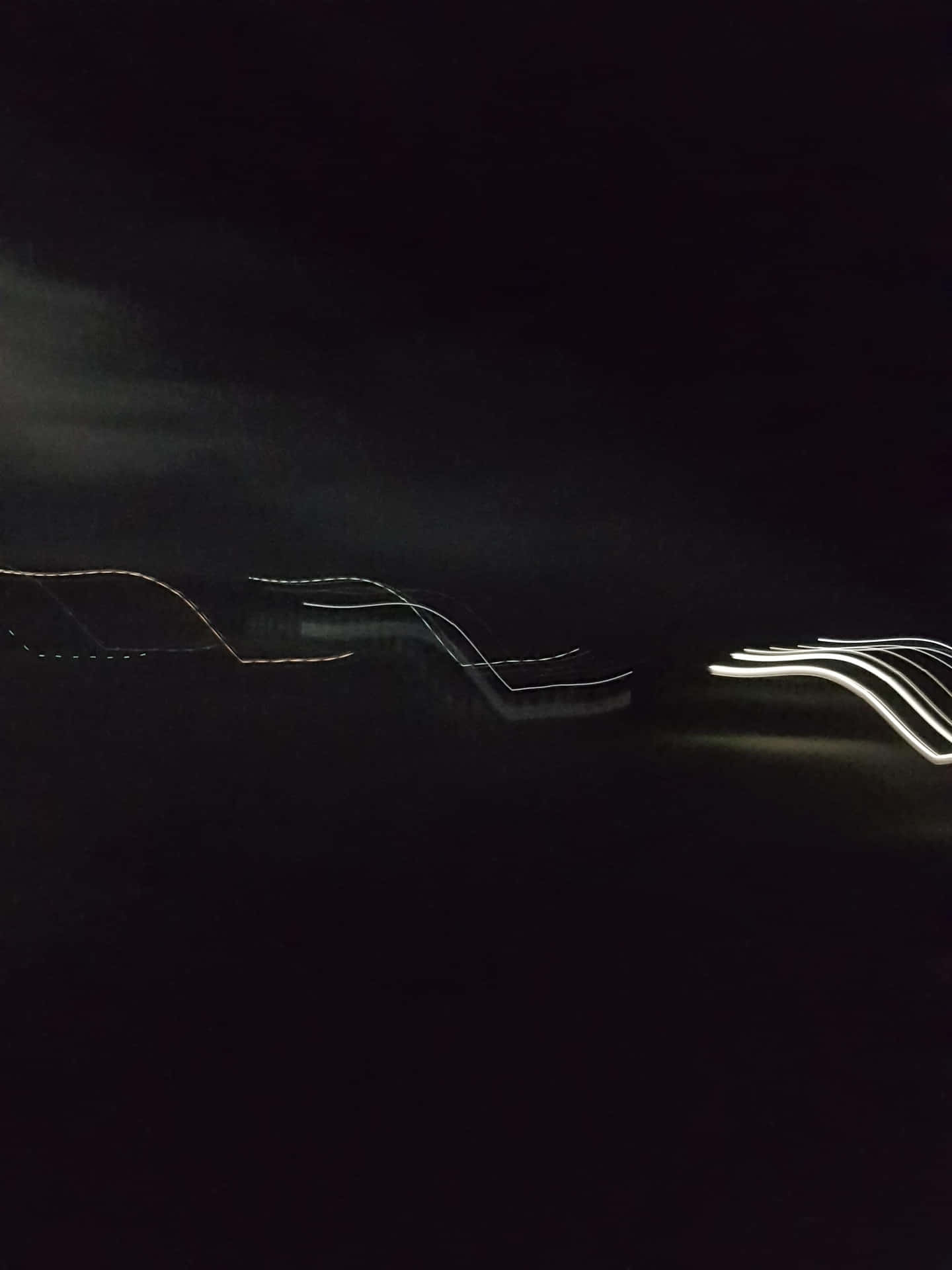 A Dark Night With Light Streaks In The Sky