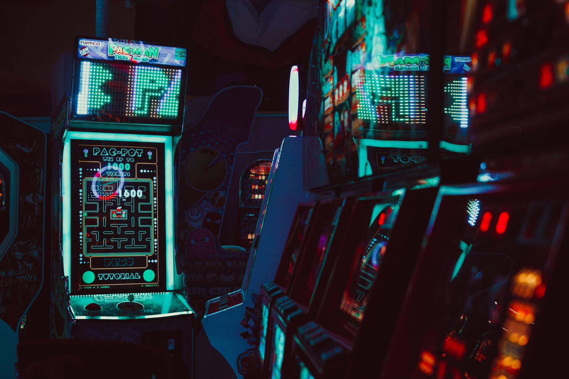 A Dark Room With Many Gaming Machines