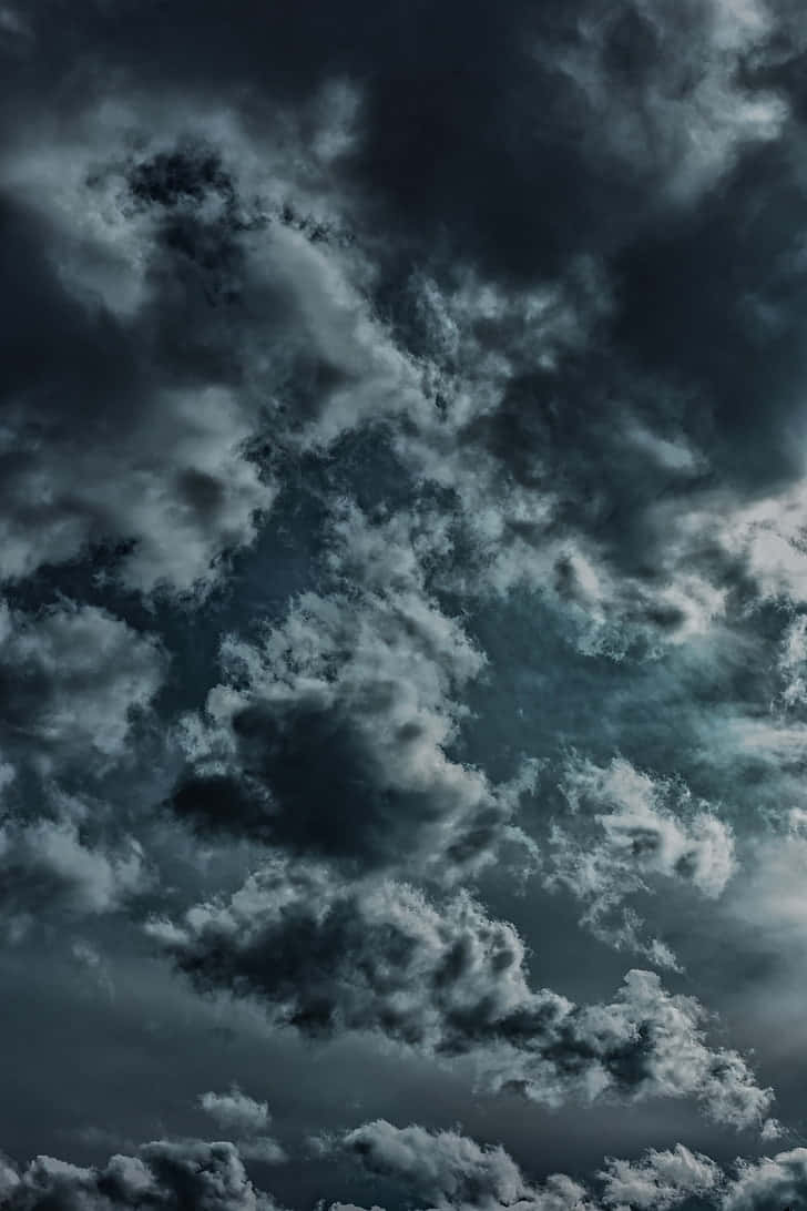 A Dark Sky With Clouds And A Moon Background