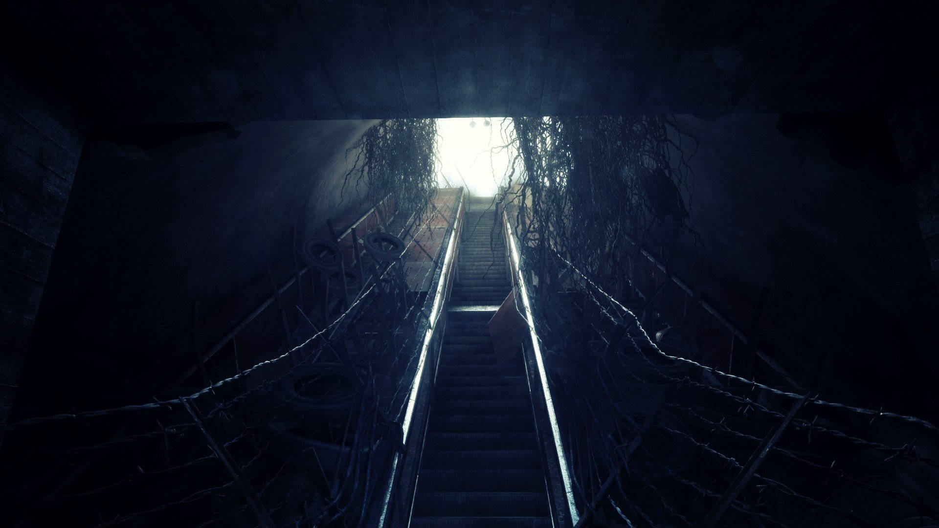 A Dark Stairway With A Light Shining Through Background