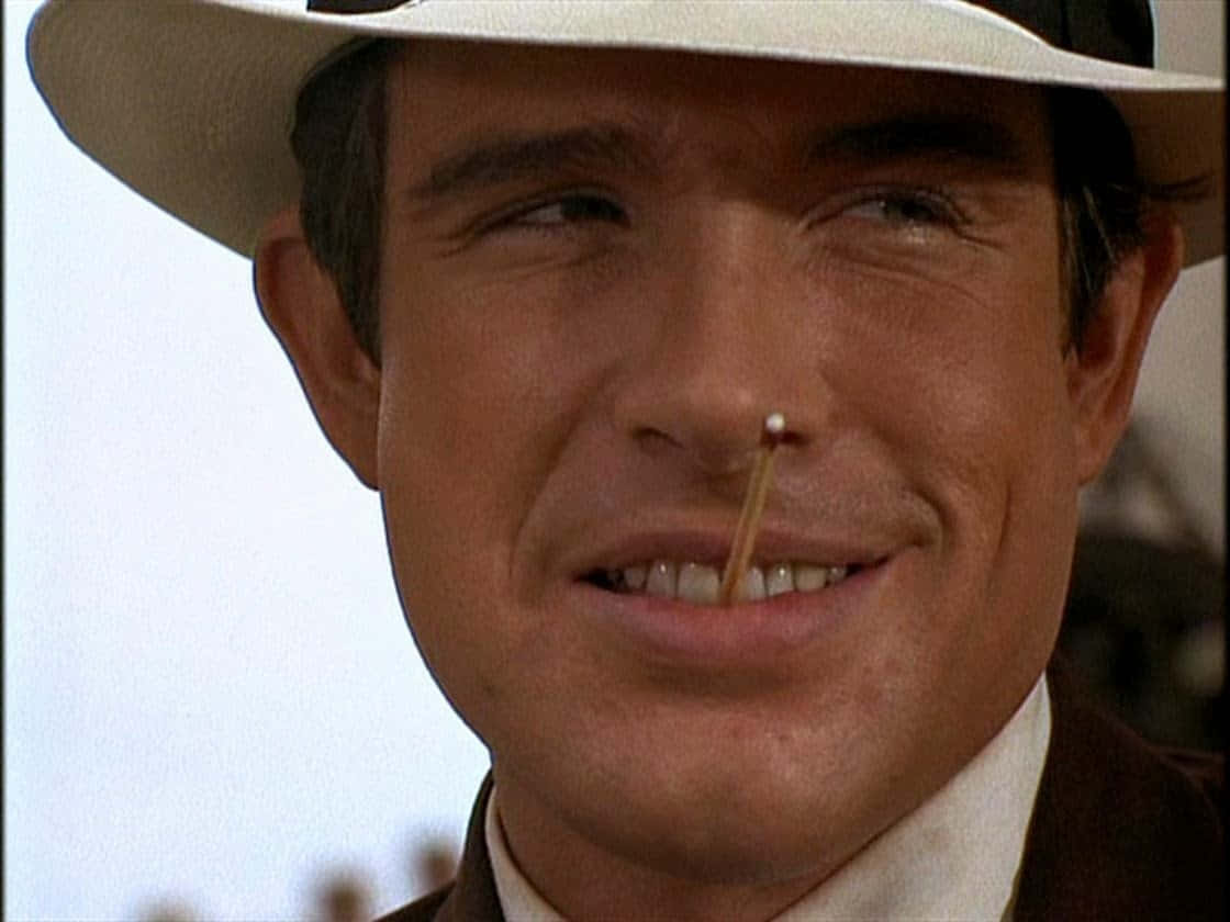 A Dashing Warren Beatty Poses In A Classic Black-and-white Portrait. Background
