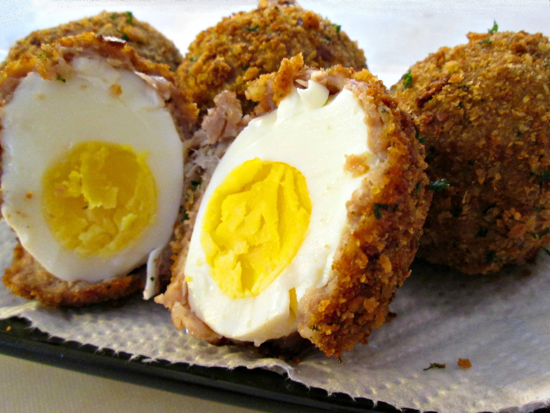 A Decadent Dish Of Crunchy Scotch Eggs Background