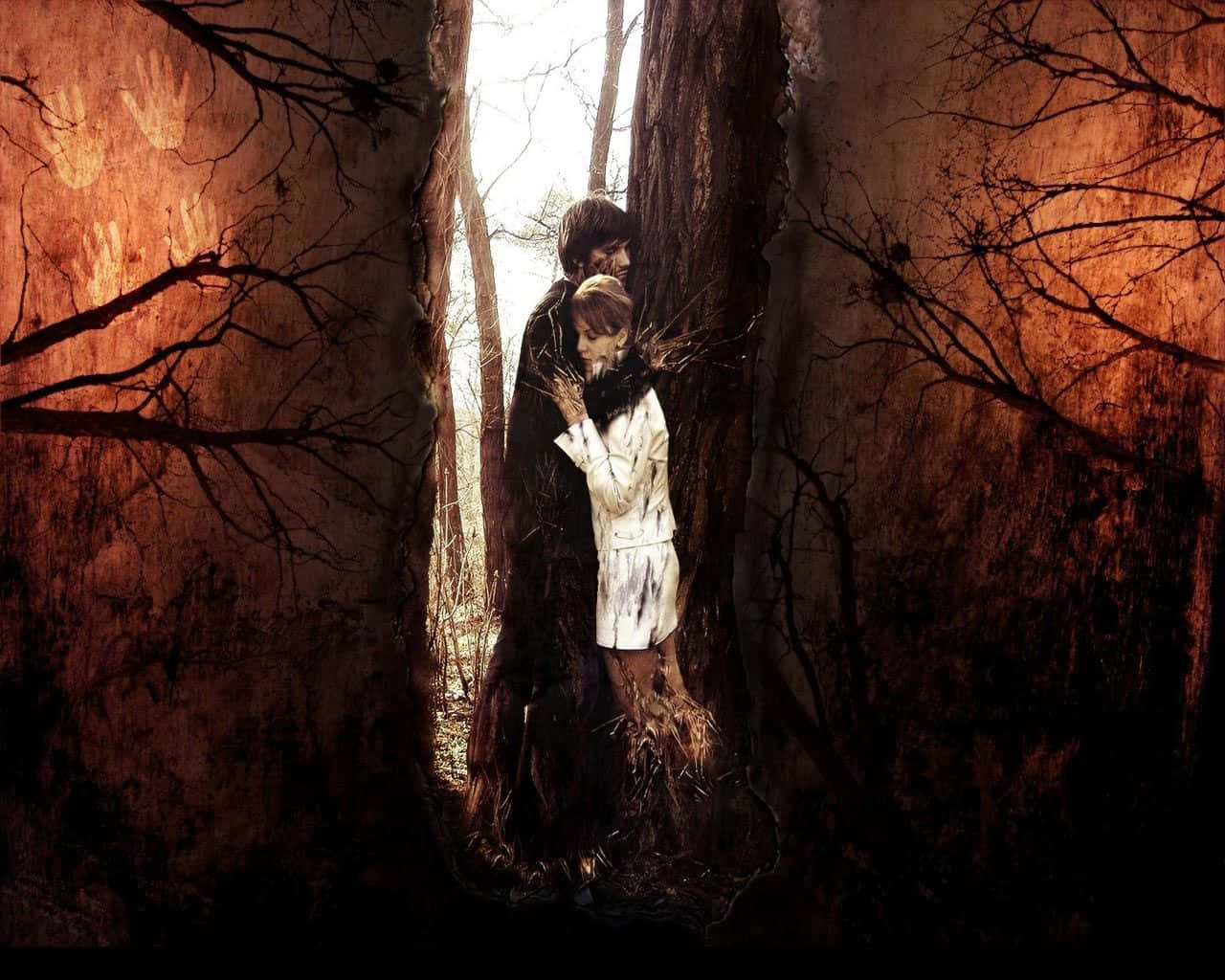 A Dejected Couple Amidst Enchanting Yet Spooky Trees Background