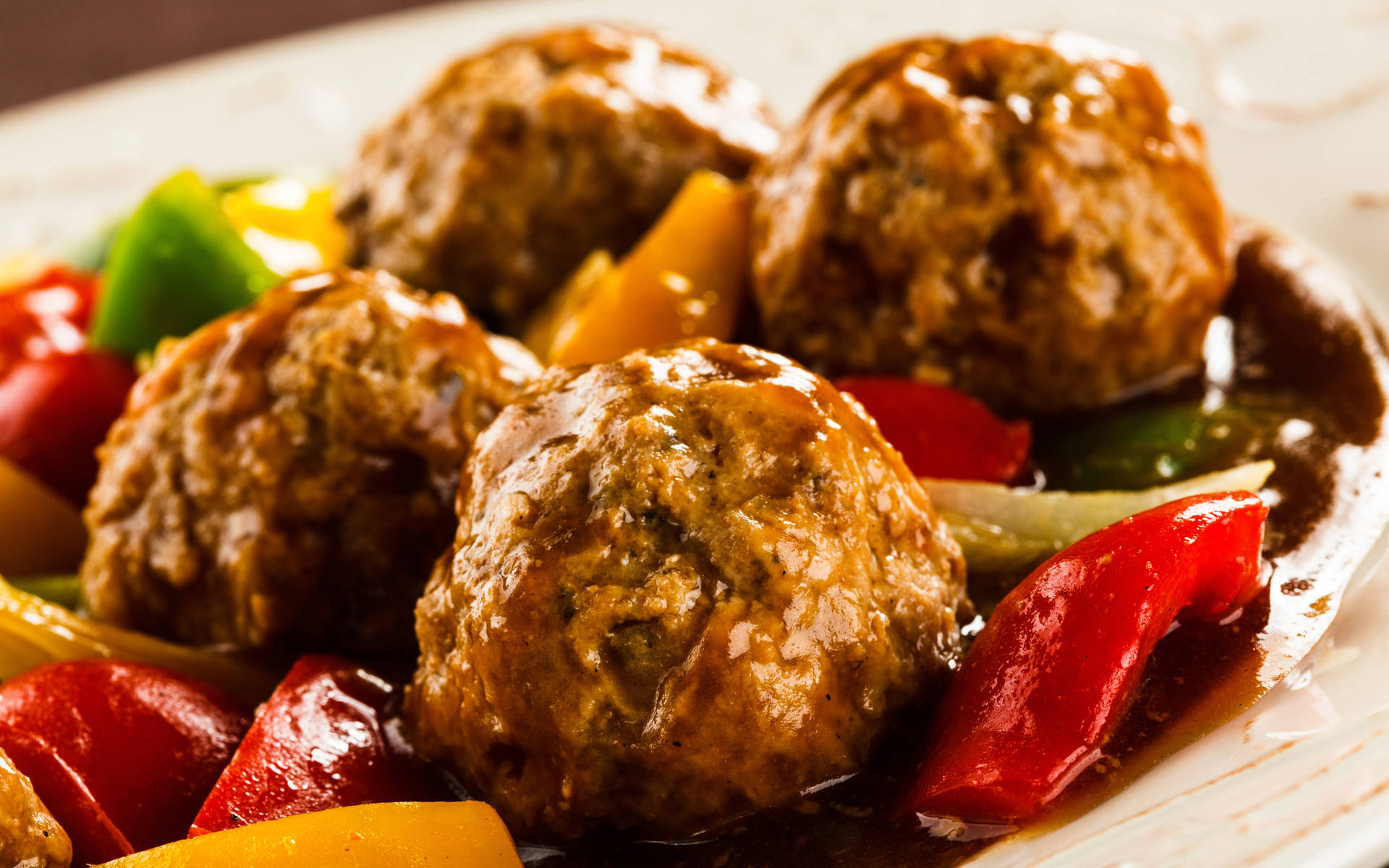 A Delectable Close-up Of Meat Balls In Tomato Sauce With Bell Pepper
