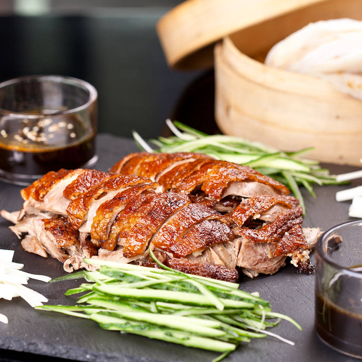 A Delectable Feast: Crispy Glazed Roasted Peking Duck Served With Vibrant Green Beans Background