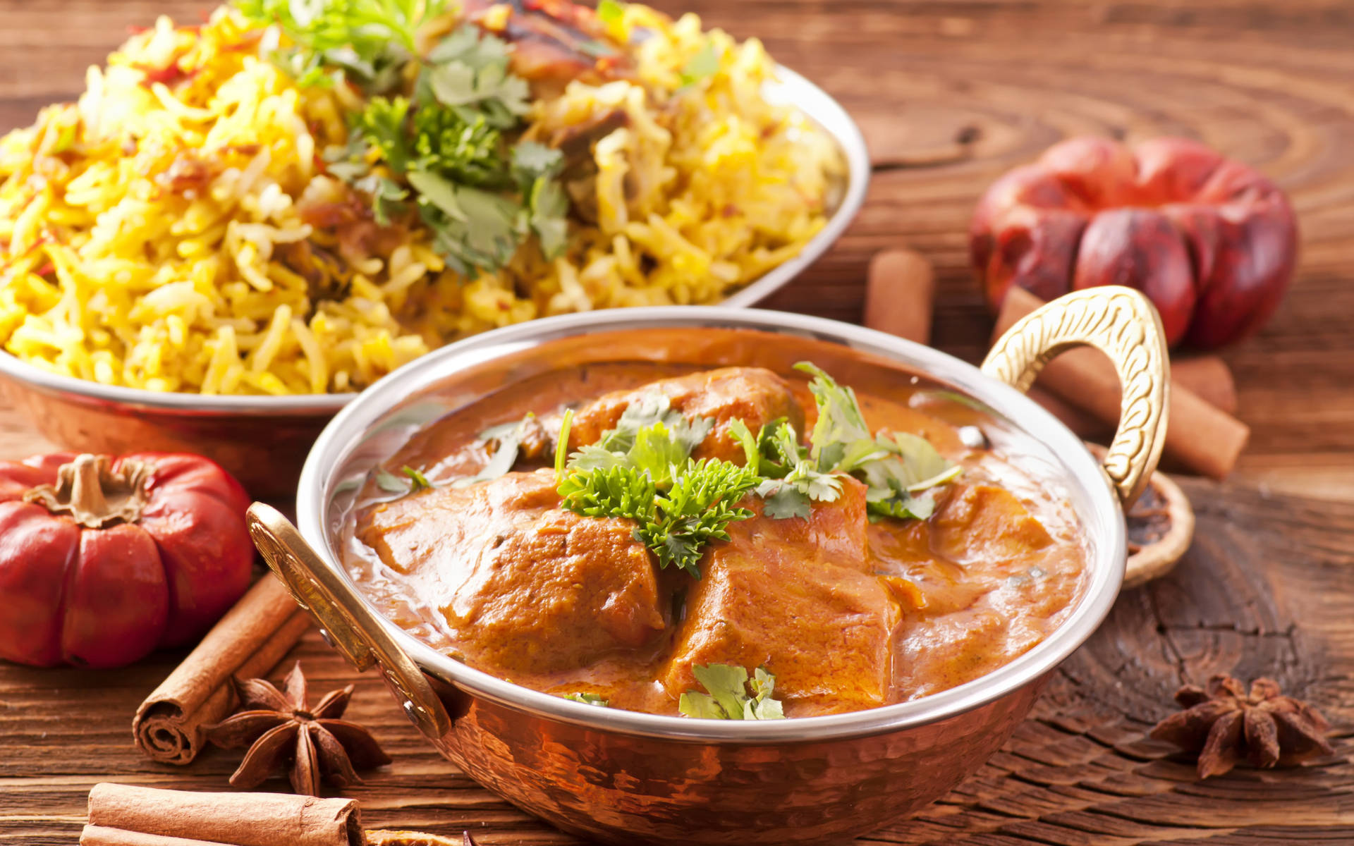 A Delectable Lunch With Butter Chicken And Biryani Rice Background