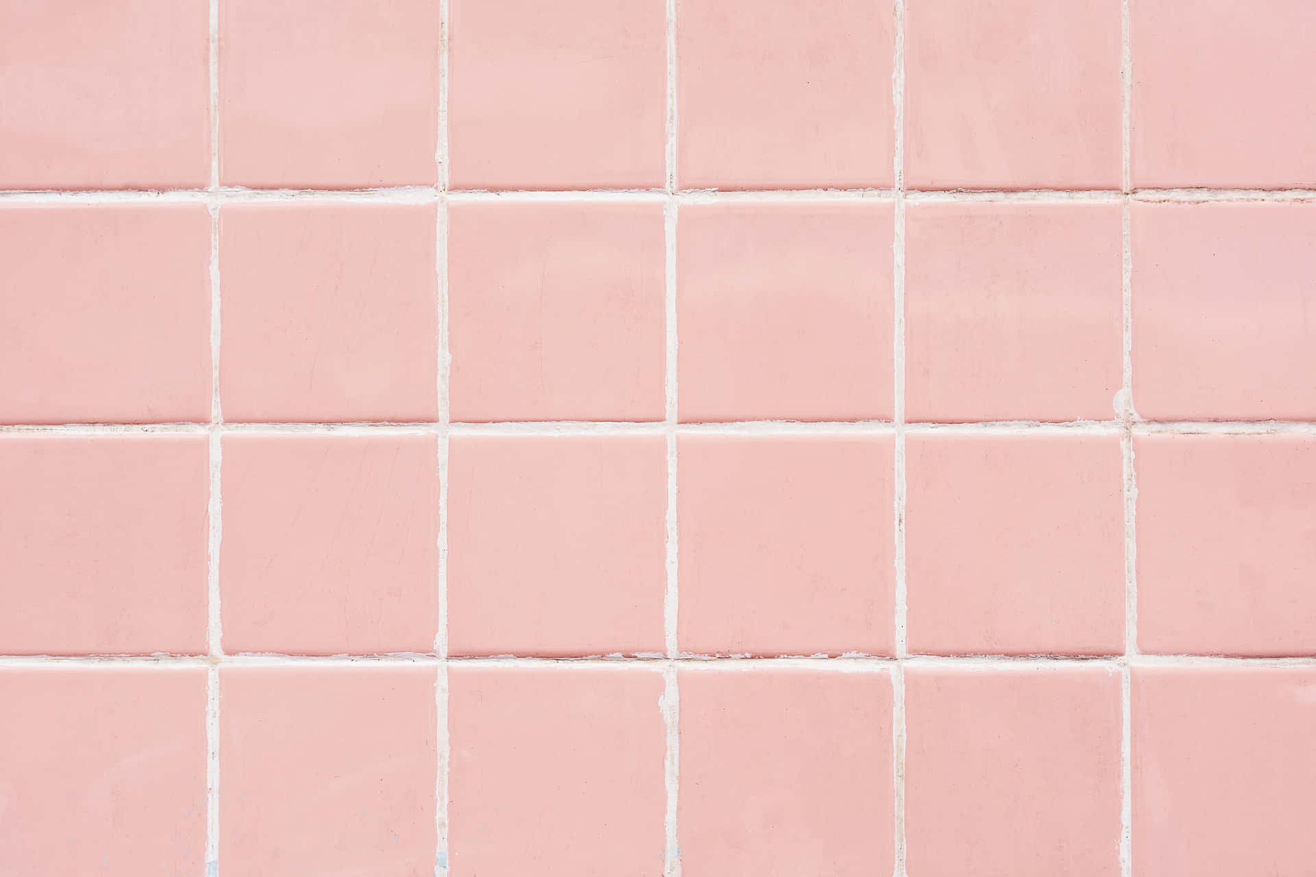A Delicate, Pastel Pink Laptop Sits Atop A Marble Desktop. Background